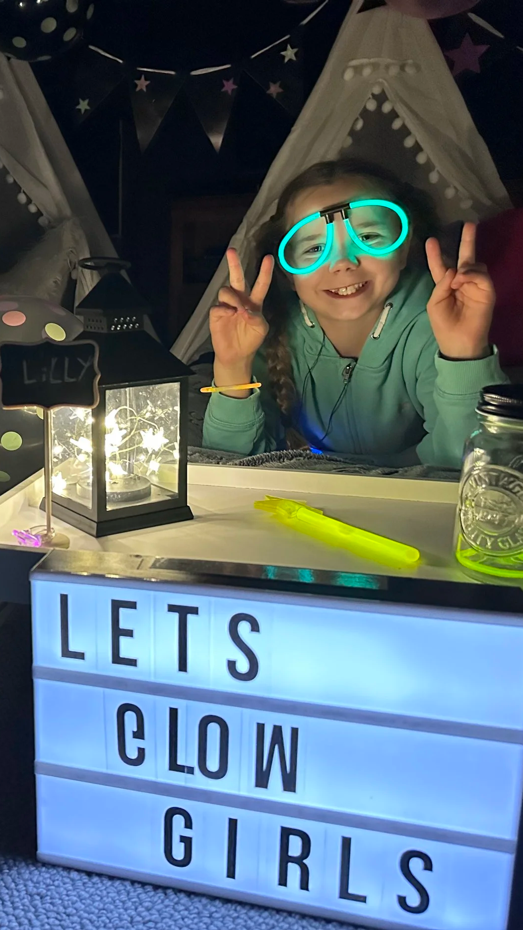 Glowing sticks, neon lights and glow in the dark setup all ready for Glow In The Dark slumber party.