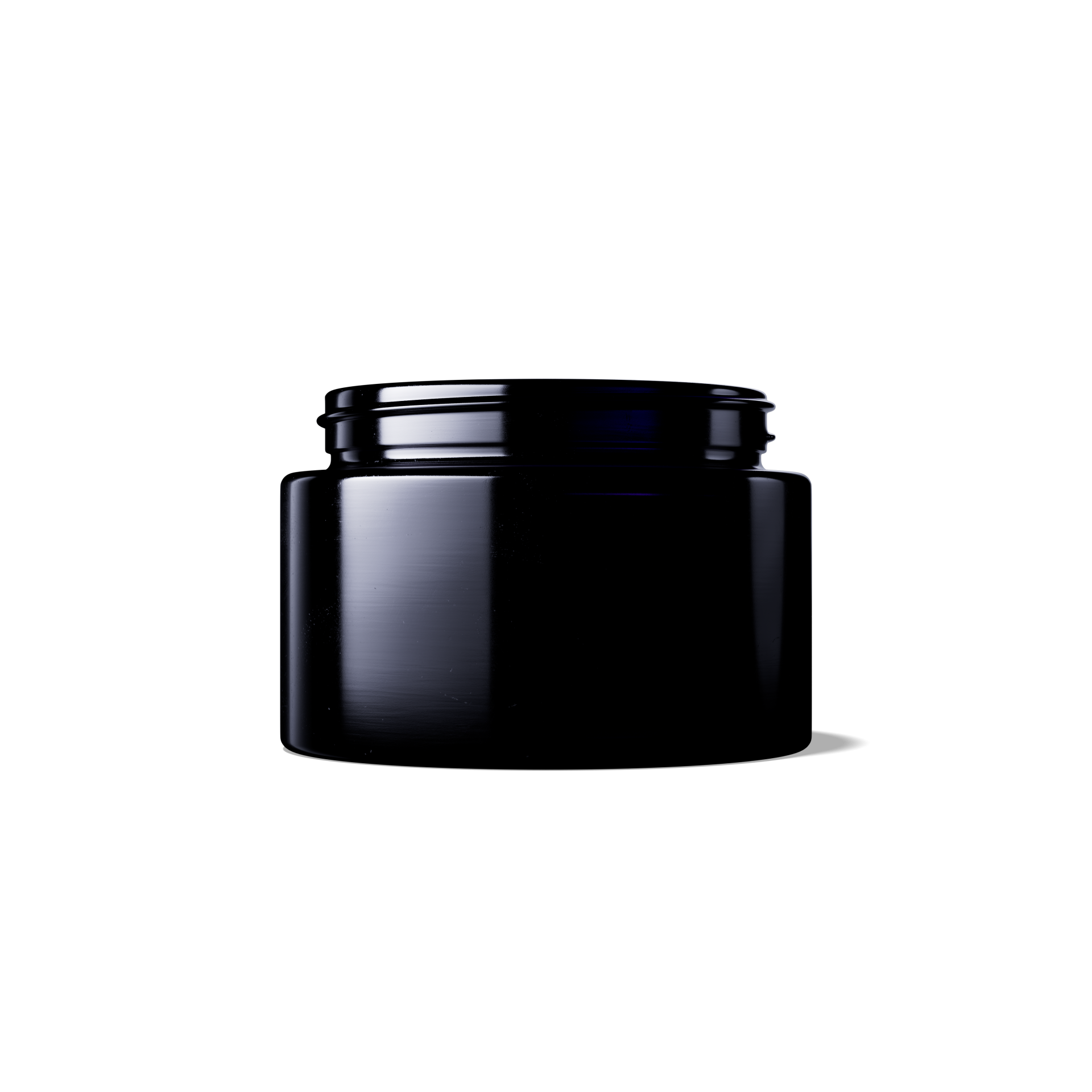 Close-up of a black jar with a minimalist design, illuminated against a dark background.