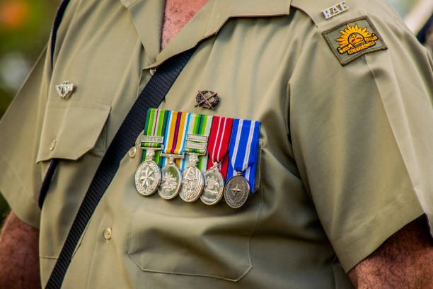 Close-up of a person's uniform with several military medals on the chest.