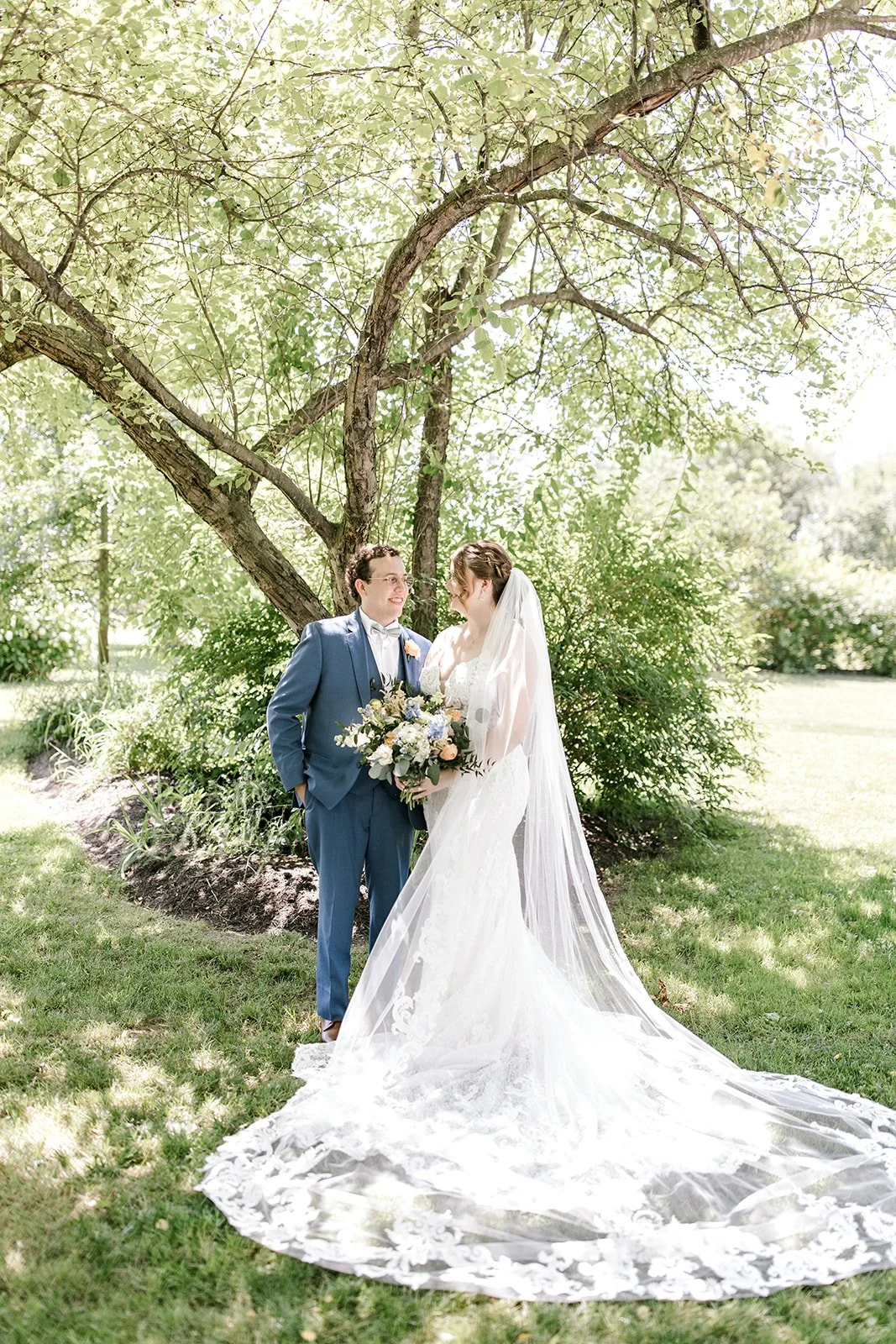Bride and groom share a joyful moment during their Gish Barn wedding in Rittman, Ohio planned by MTM Weddings & Events.