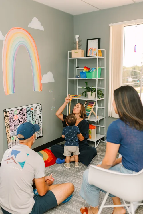 Therapist working with a child and parent together at 143 Speech Therapy in Clive Iowa