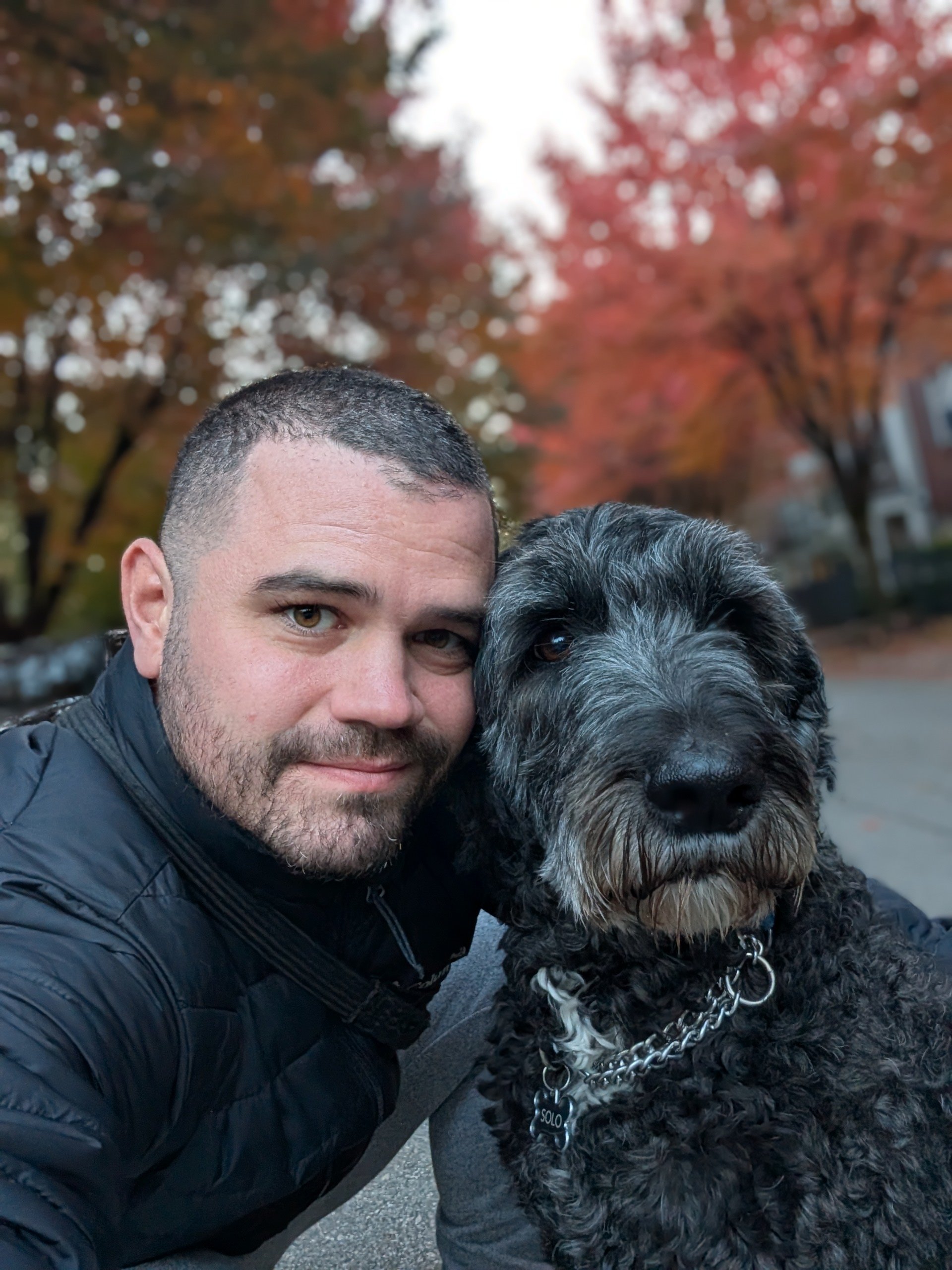 Aaron Demes and his sheepadoodle dog, Solo.