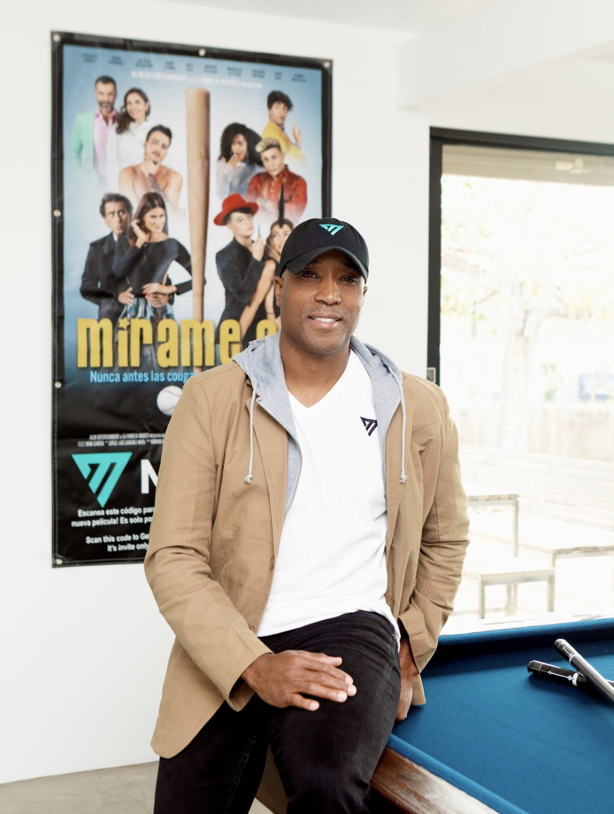 Terrell Samuels leaning on a pool table