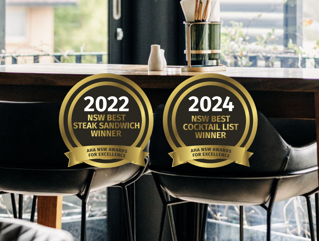 Awards plaque on a restaurant table with a modern interior and large window in background.