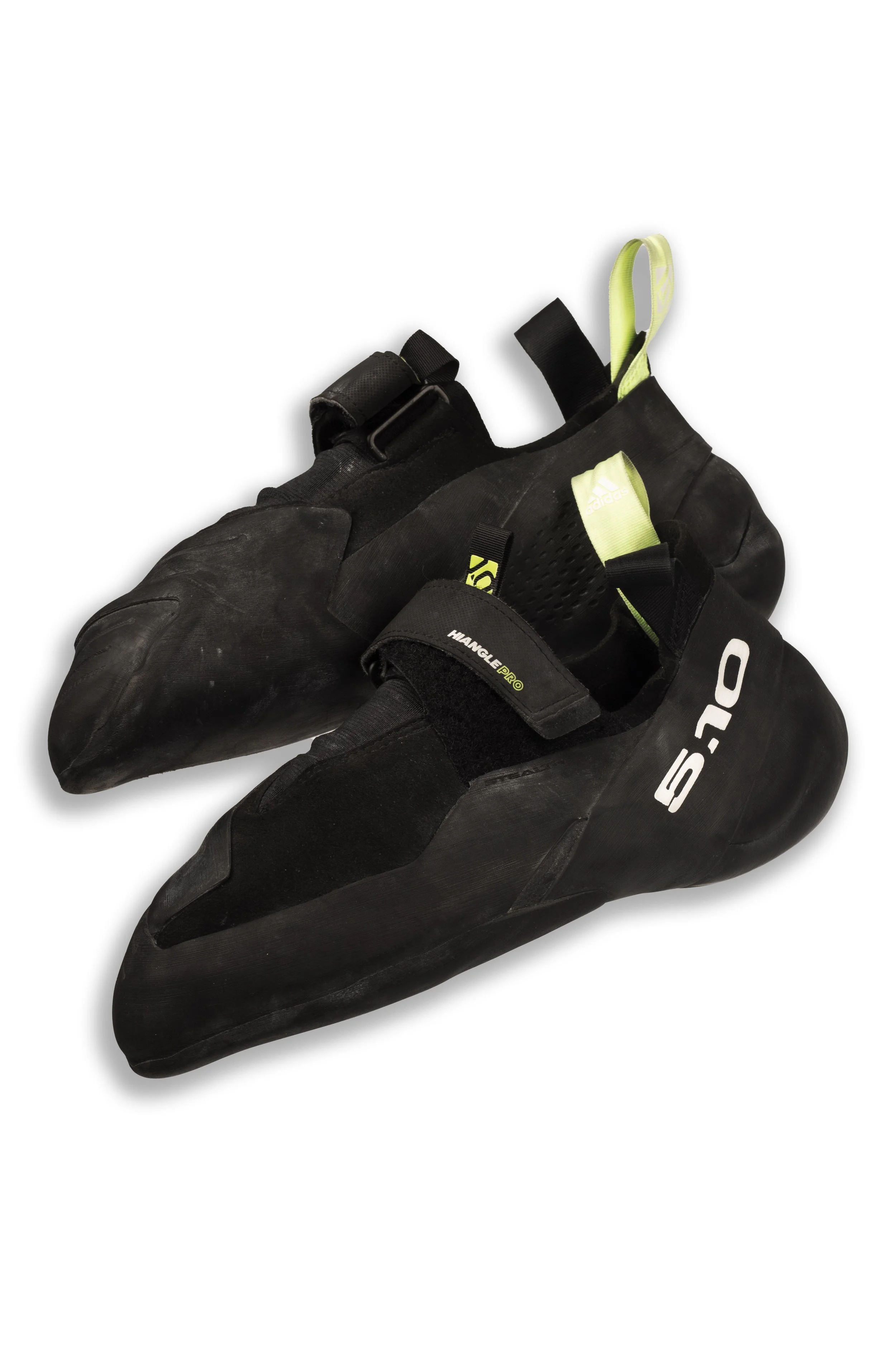 A pair of black rock climbing shoes with Velcro straps and white and yellow accents.