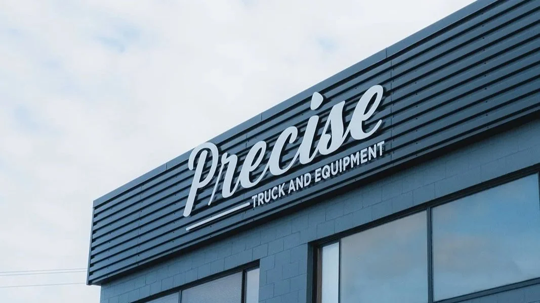 Sign on a building reading 'Precise Truck and Equipment'