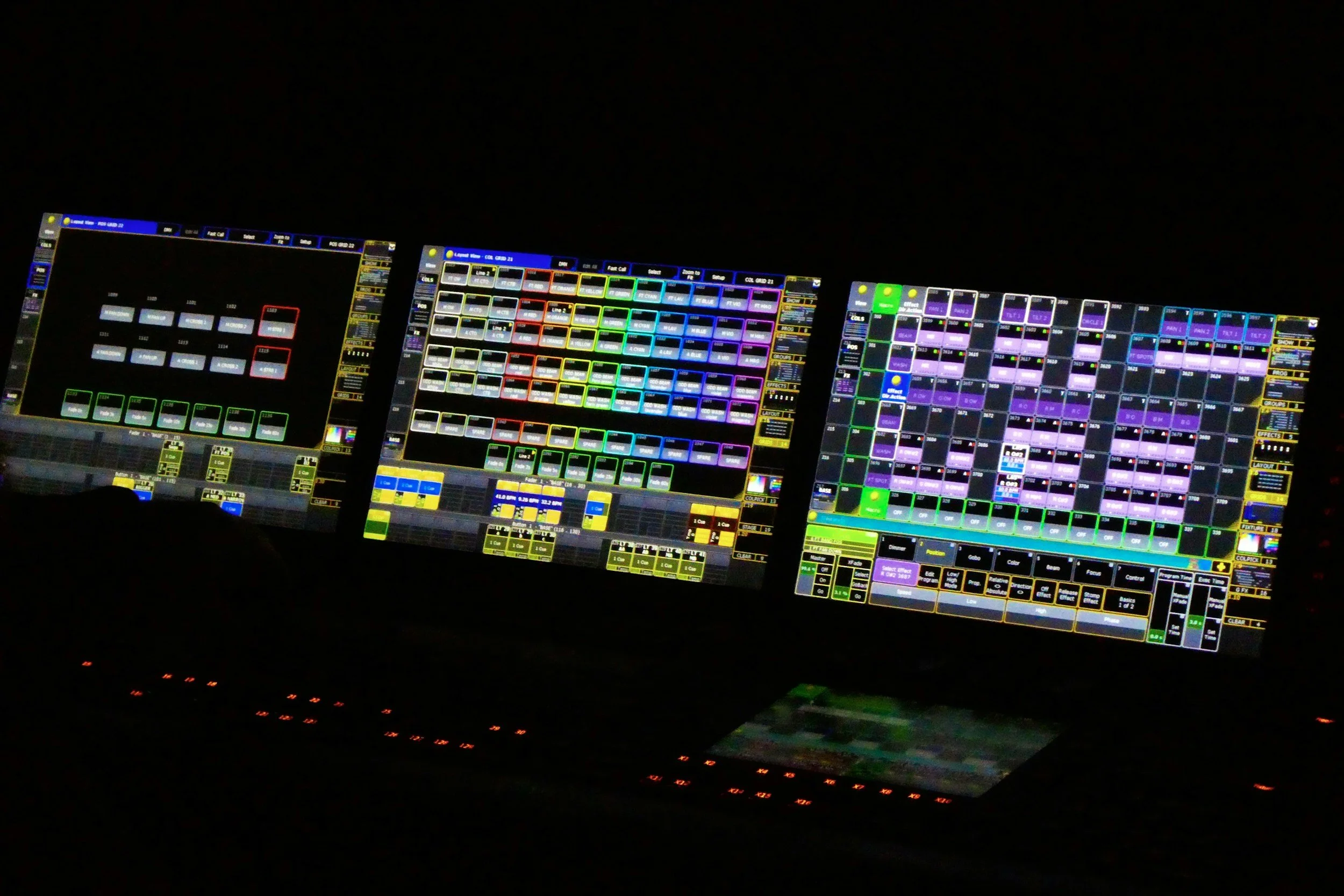Three computer screens displaying a digital audio workstation with colorful controls and waveforms, set against a dark background.