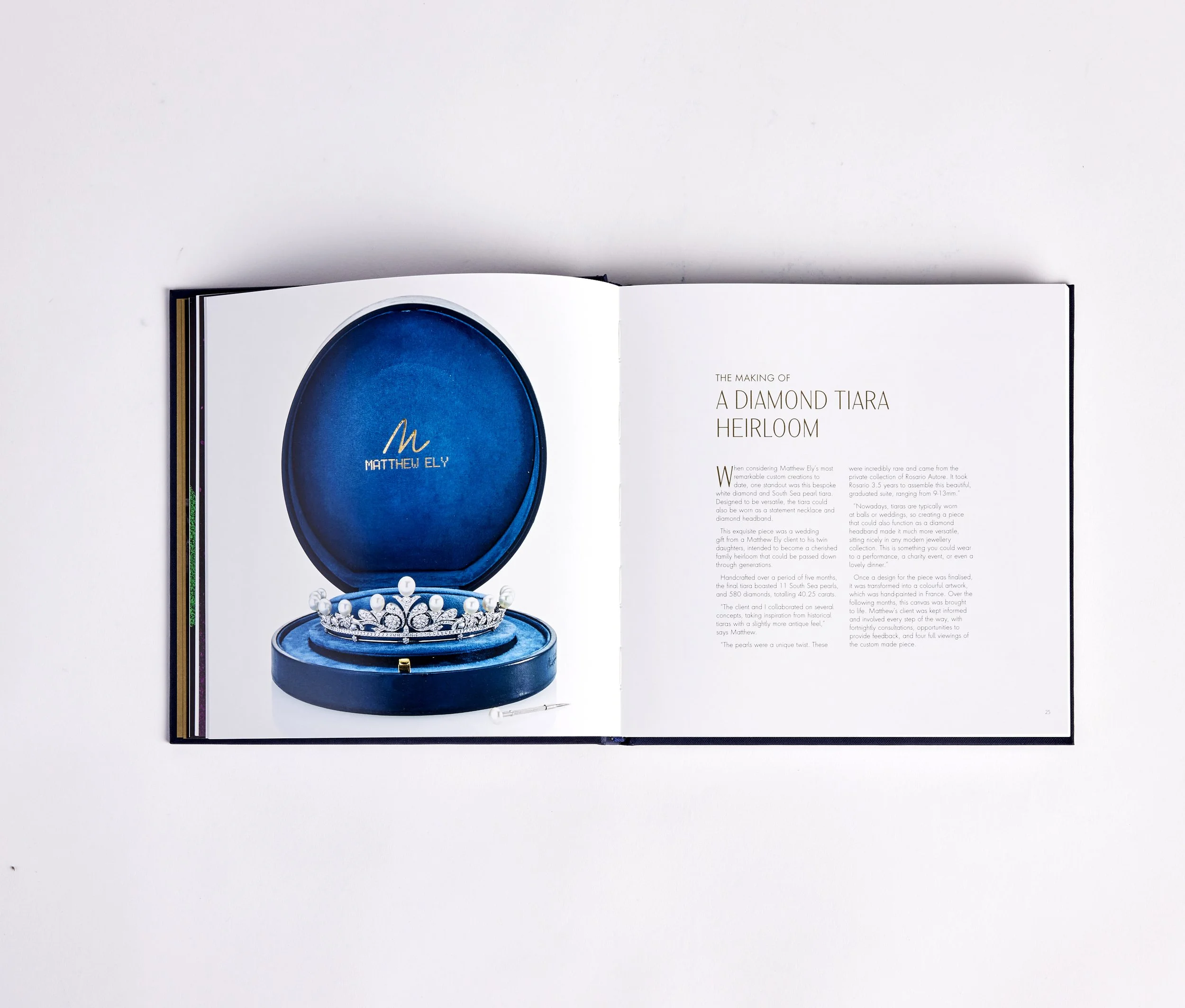 Open book displaying a photo of a blue jewelry box with a diamond tiara inside on the left page and text describing the making of a diamond tiara heirloom on the right page.