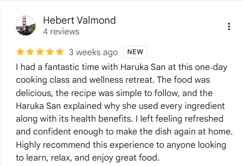 Screenshot of a 5-star review by Hebert Valmond for a cooking class and wellness retreat, praising the food, recipe simplicity, and health benefits.
