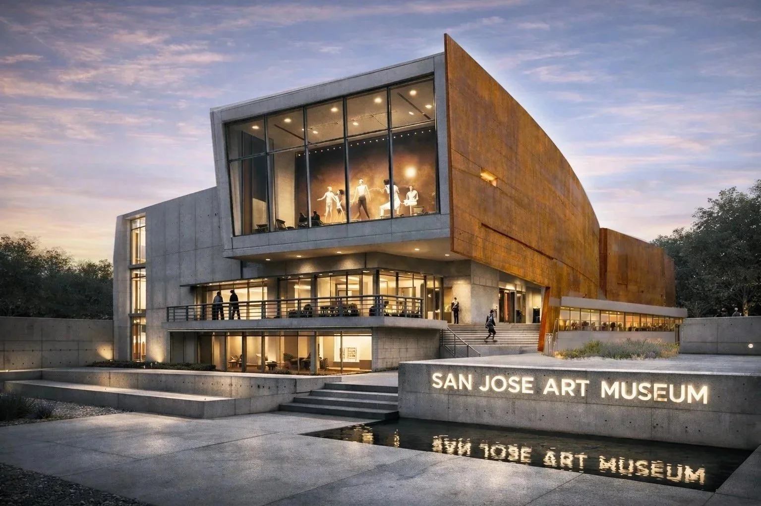 Exterior view of the San Jose Art Museum during sunset, showcasing modern architecture with large glass windows displaying mannequins and art exhibits inside, and illuminated signage reading 'SAN JOSE ART MUSEUM' at the entrance.