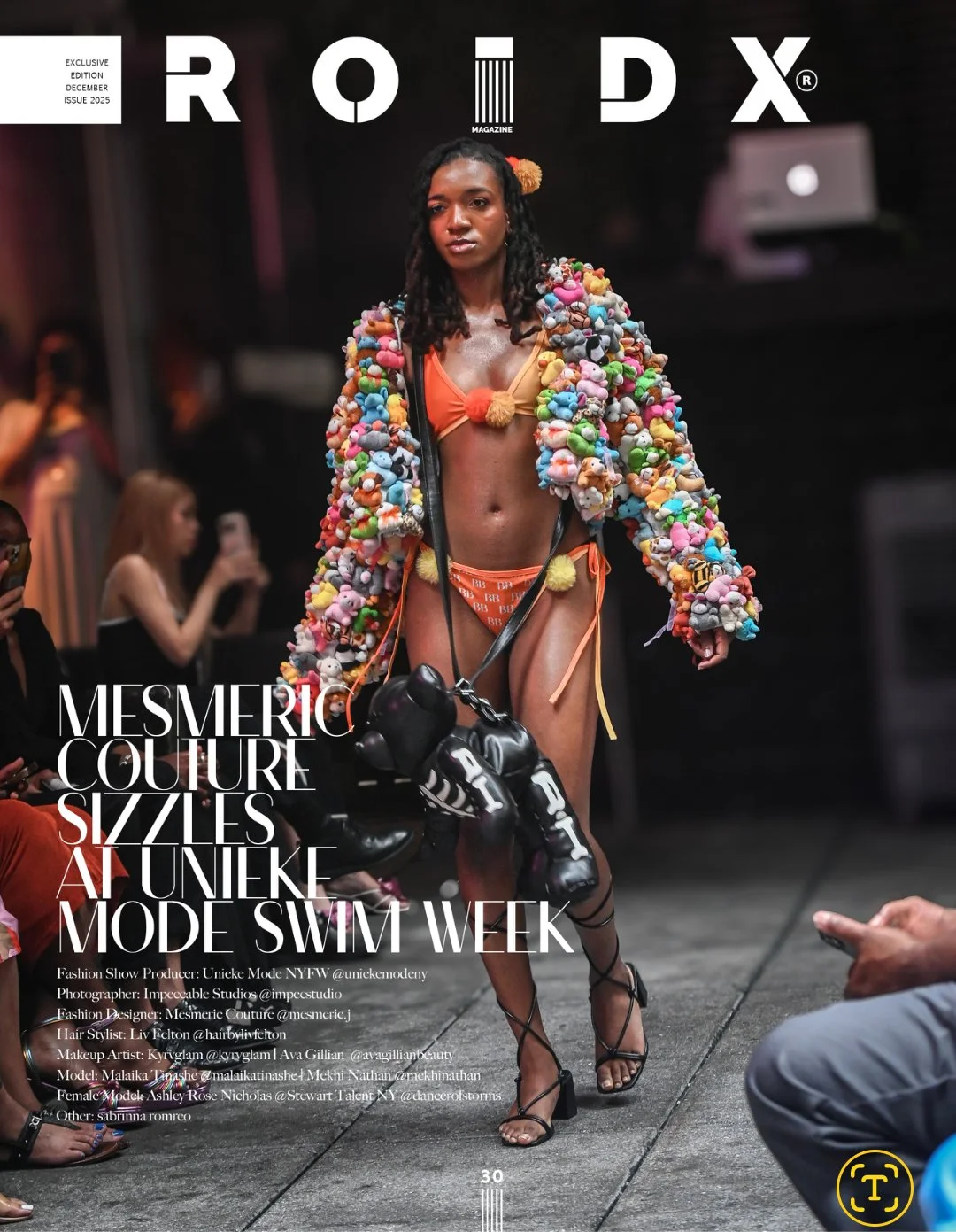 A model walks on a runway wearing a colorful, plush coat made of small, stuffed toys, a matching orange bikini, and black strappy heels during a fashion show at Unieke Mode Swim Week.