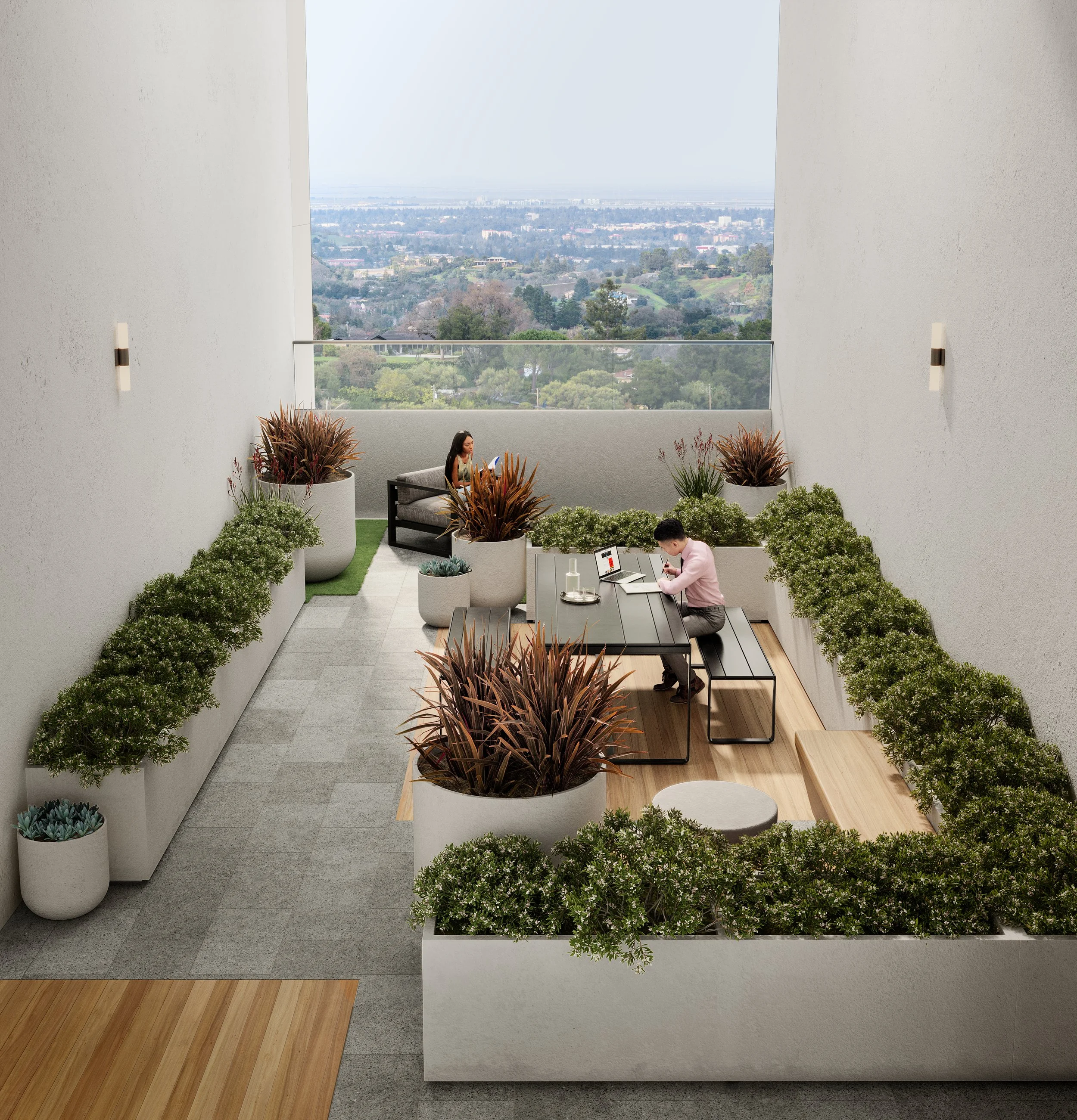Two people working on laptops in a rooftop terrace with plants and a city view.