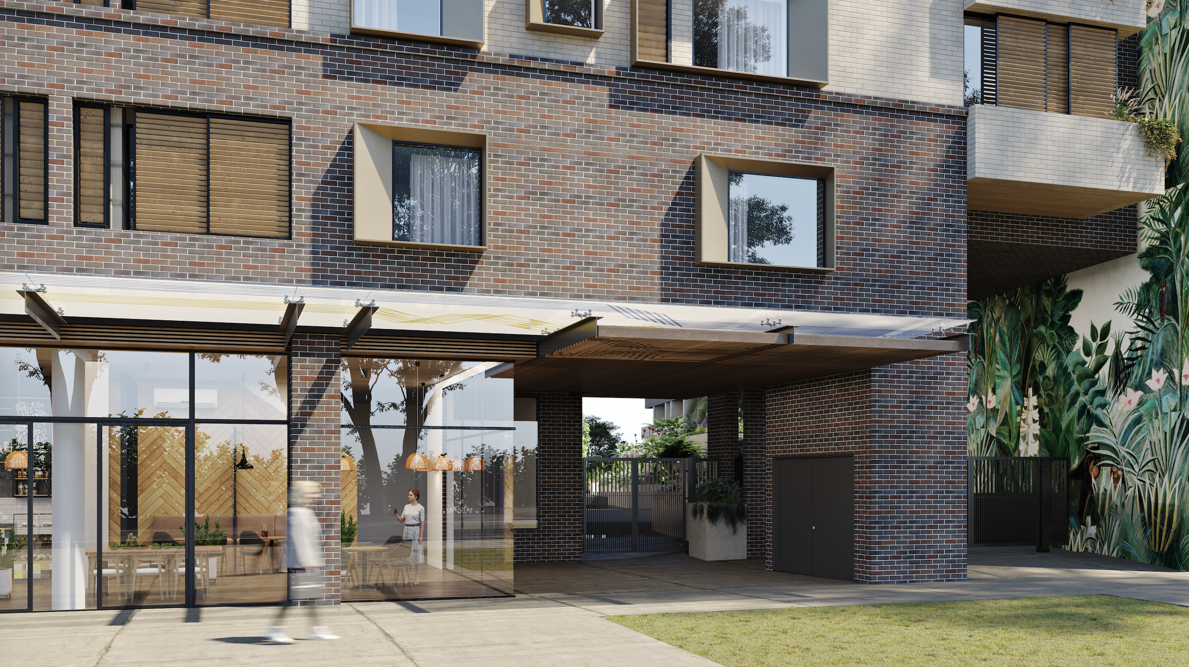 Modern multi-story brick building with large glass windows and a commercial space on the ground floor, featuring an outdoor patio and a mural with green foliage on the side wall.