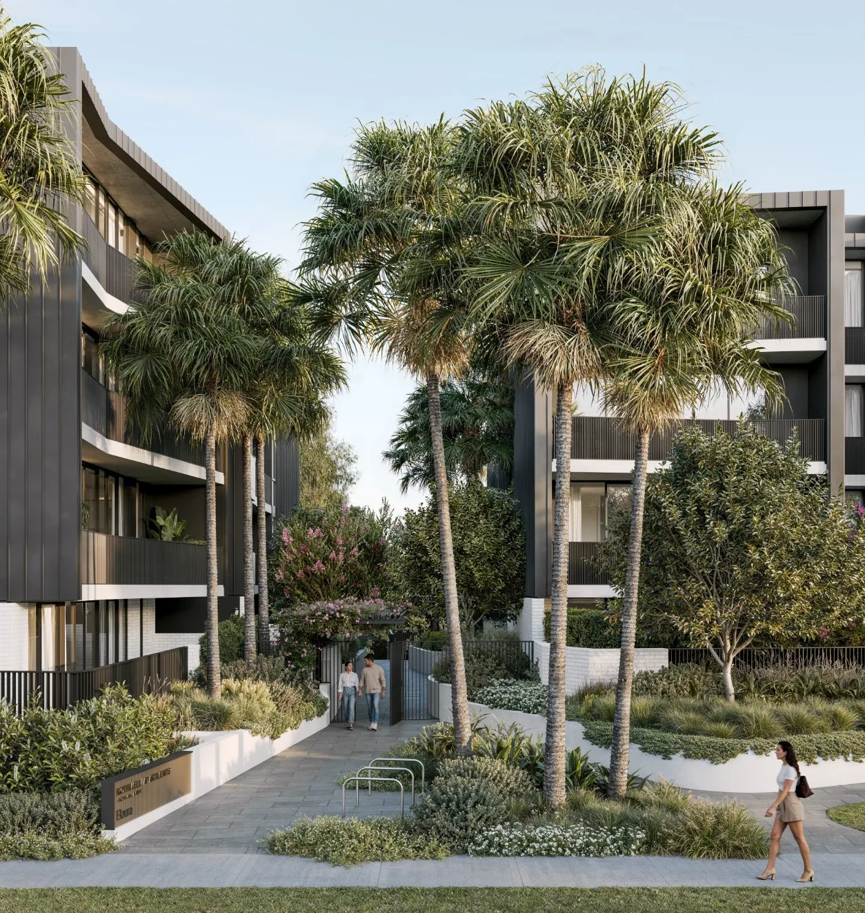 Modern apartment complex with landscaped gardens, tall palm trees, and people walking on a paved pathway.