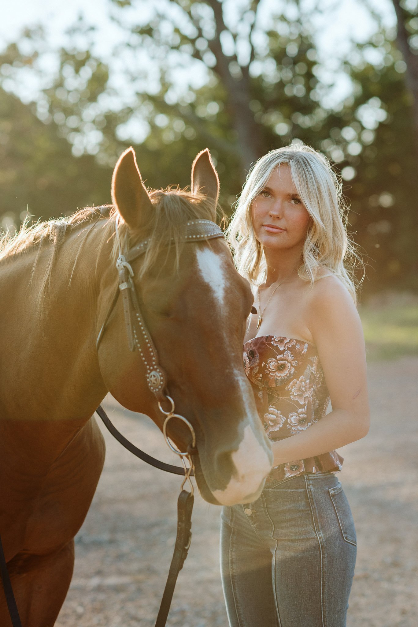 Portrait of senior girl staring at camera with her horse for senior session in North Georgia
