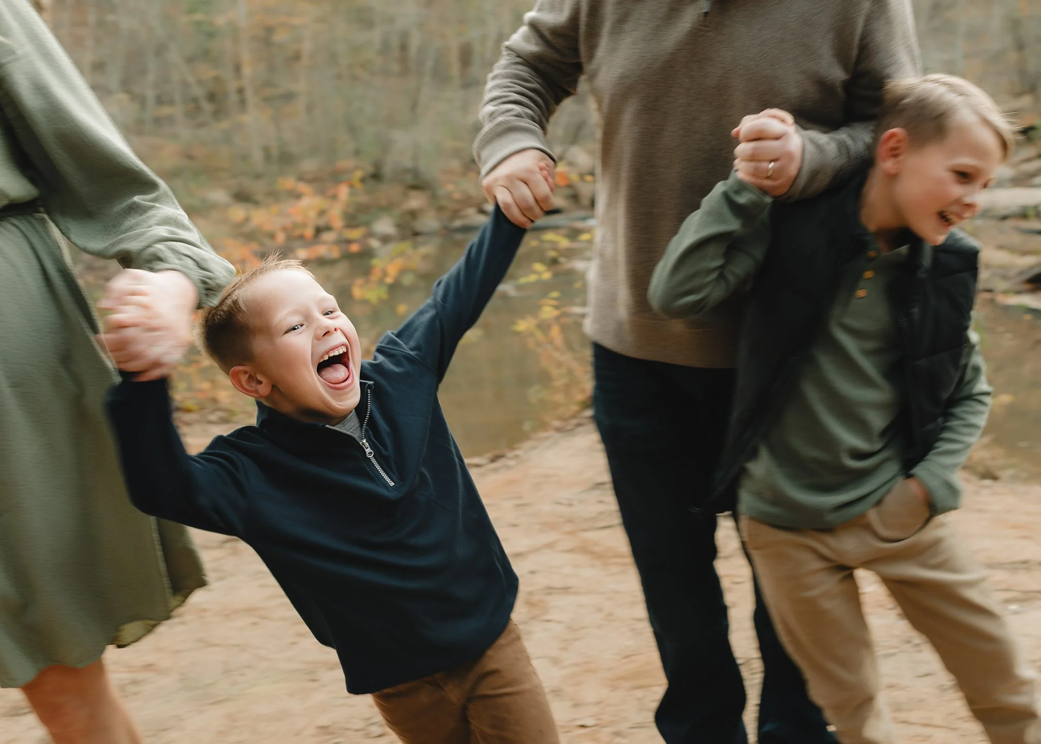 Candid boy laughing during family session in Woodstock, Georgia by Raquel Zane Photography