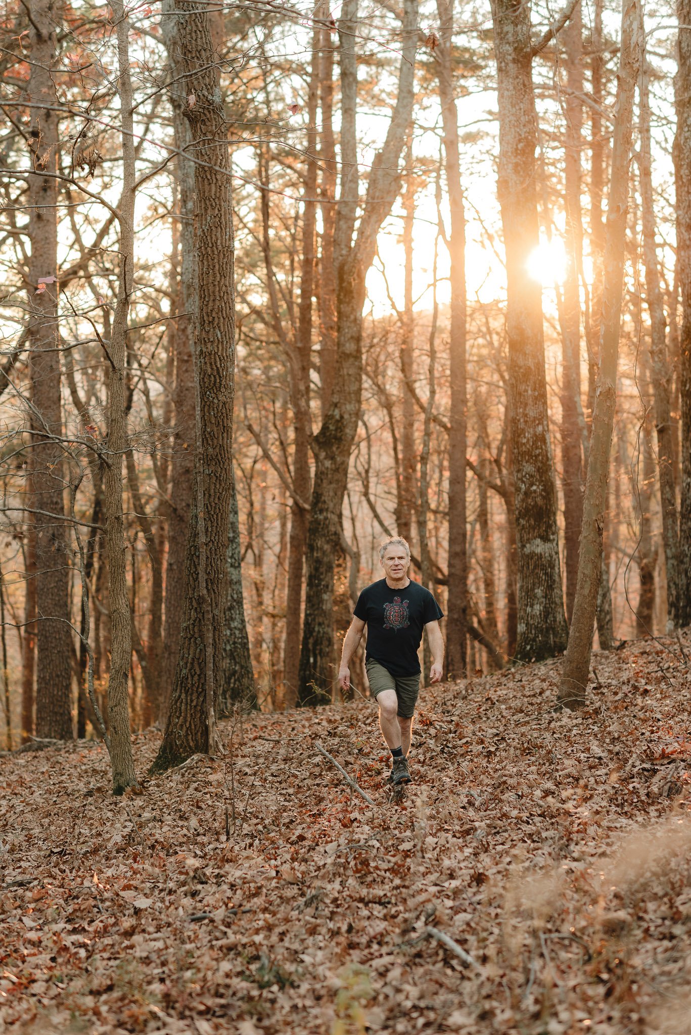 Man walking in woods with golden light portrait session in North Georgia by Raquel Zane Photography