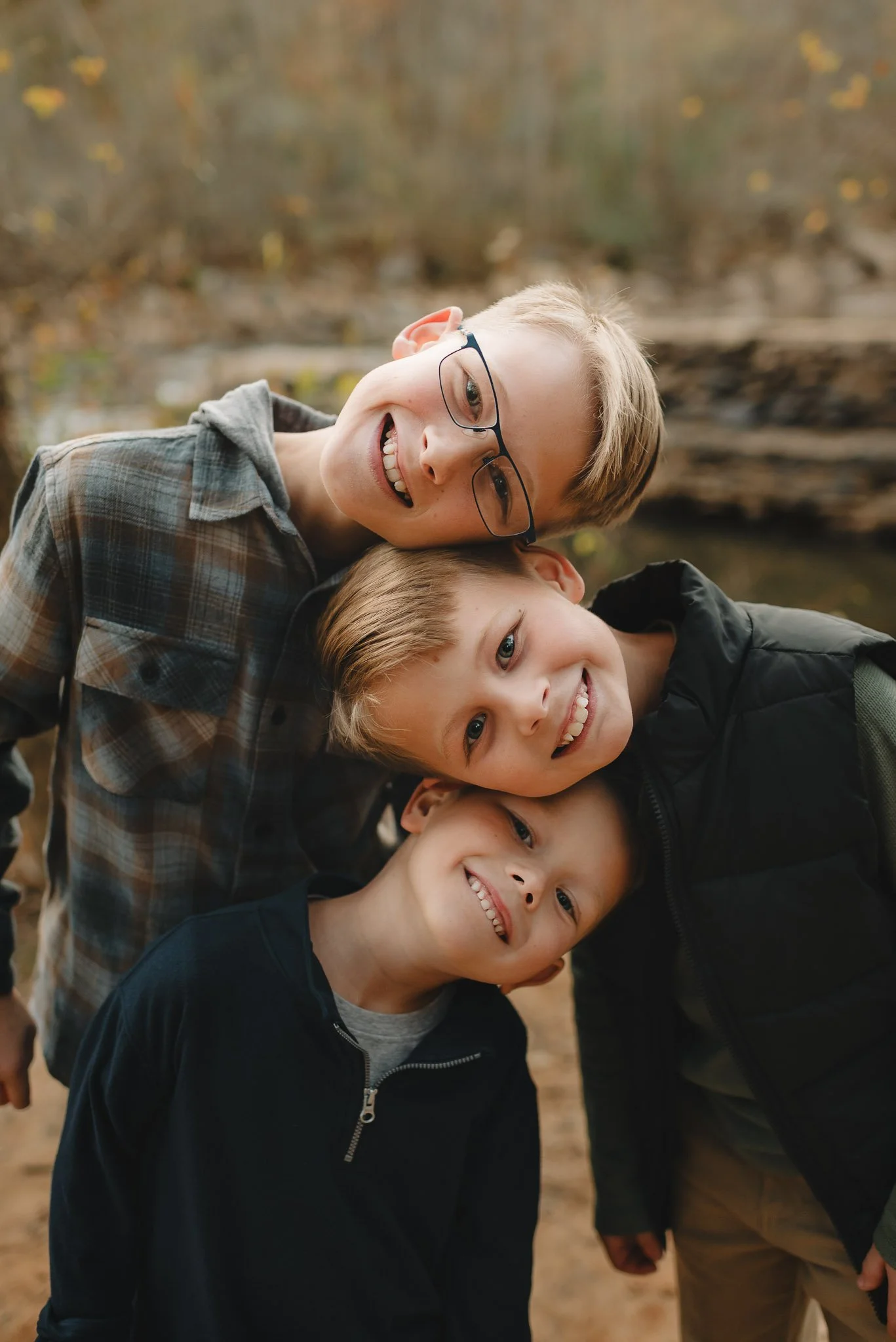 Candid brothers during family session outdoors by Raquel Zane Photography