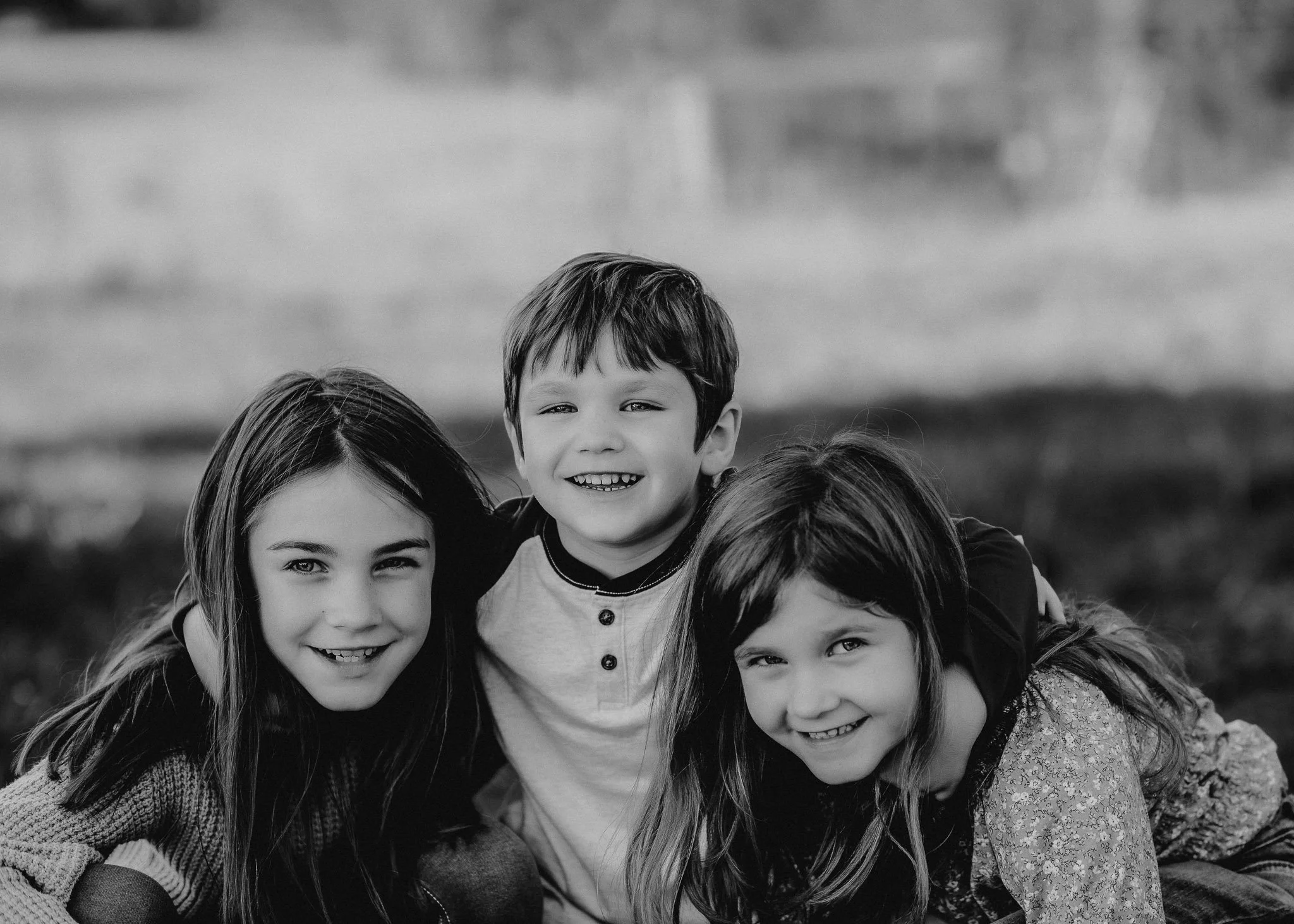 Black and white photo of children laughing outdoors in North Georgia