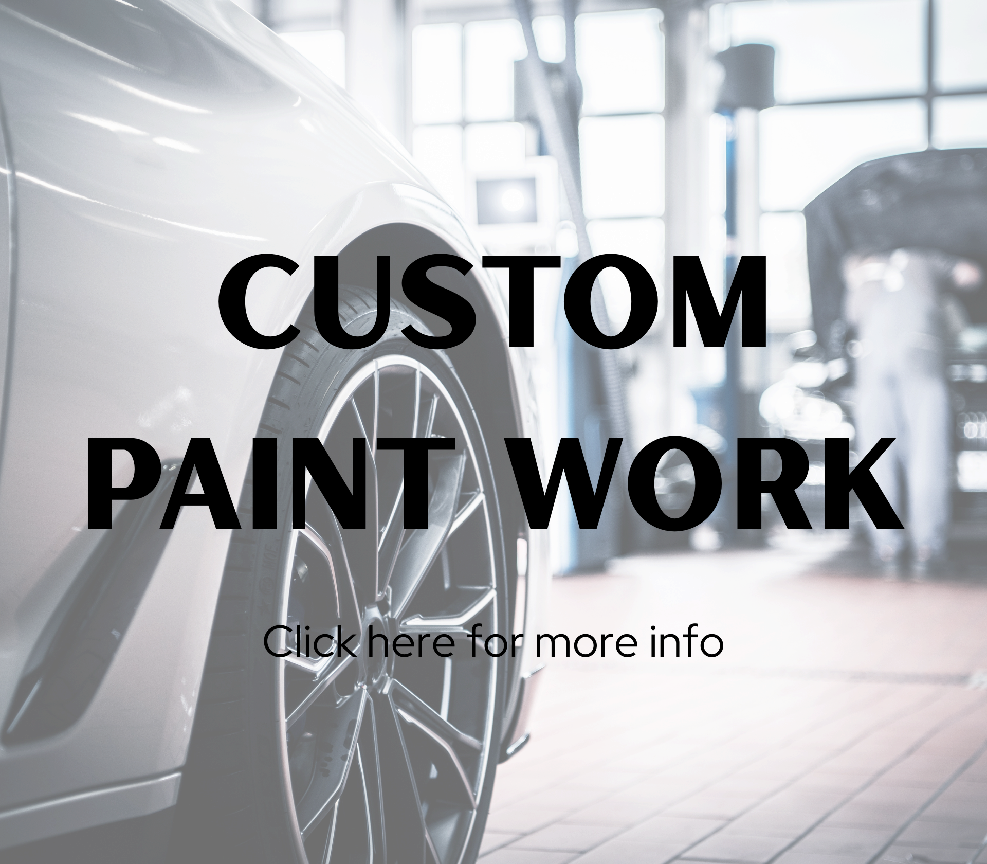 Inside an auto repair shop, a white car is being serviced with a focus on the front tire and wheel, while a mechanic possibly works in the background.