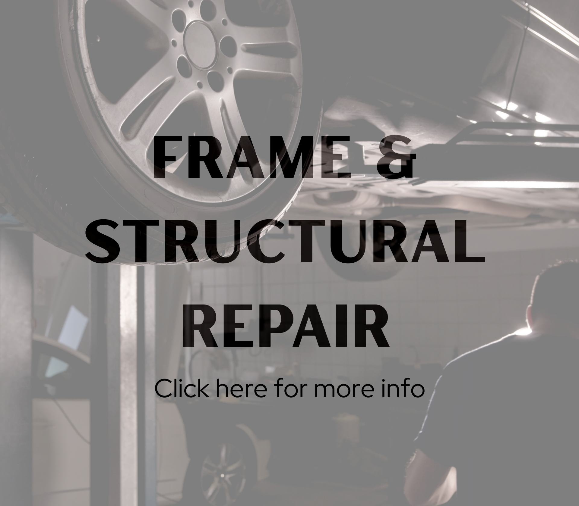 A car's wheel is prominently visible from underneath at an auto repair shop, with a mechanic working on the vehicle in the background, illuminated by workshop lighting.
