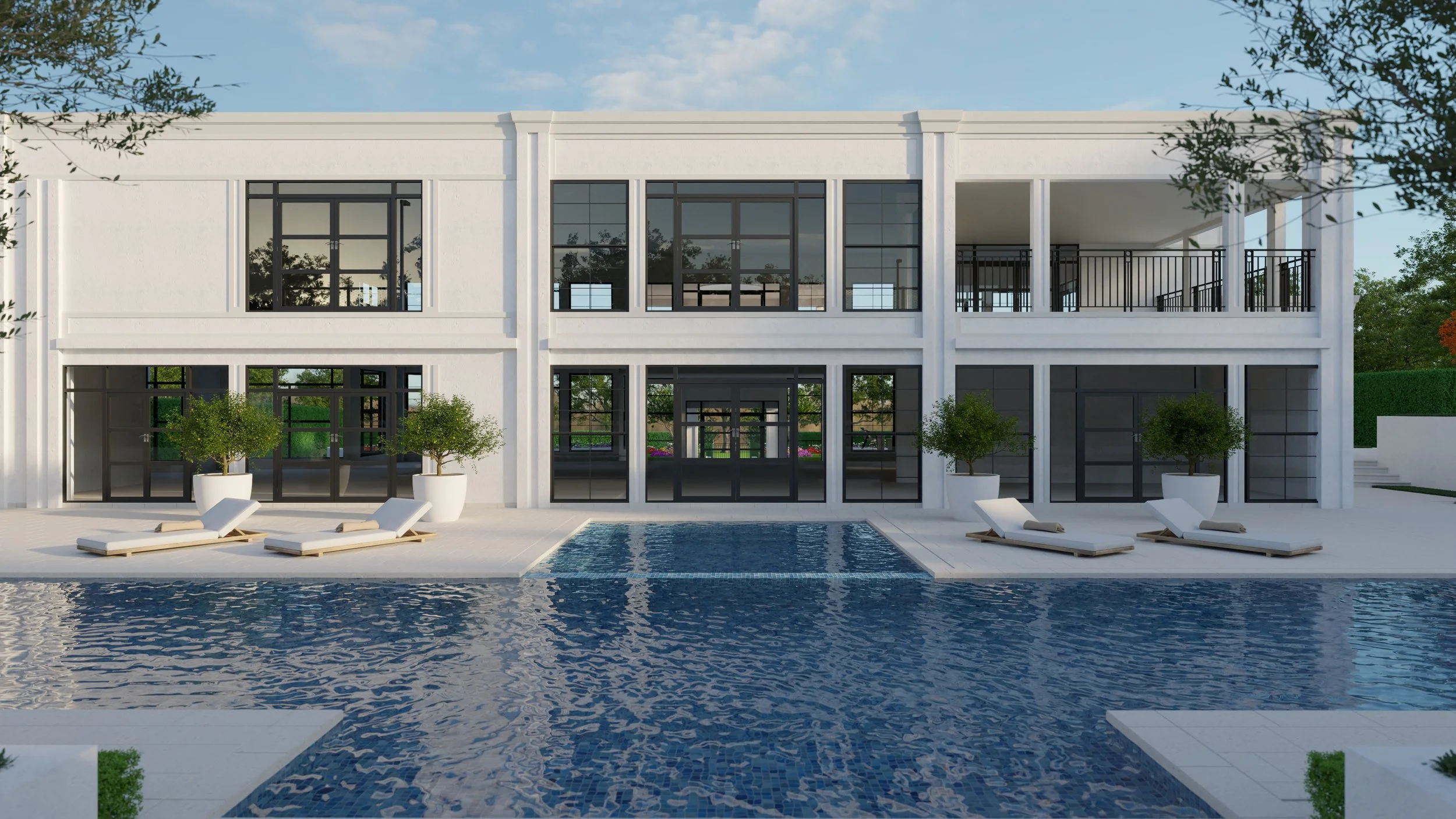 Modern white two-story building with large black-framed windows and an outdoor swimming pool in front, surrounded by poolside lounge chairs and potted trees, under a partly cloudy sky.