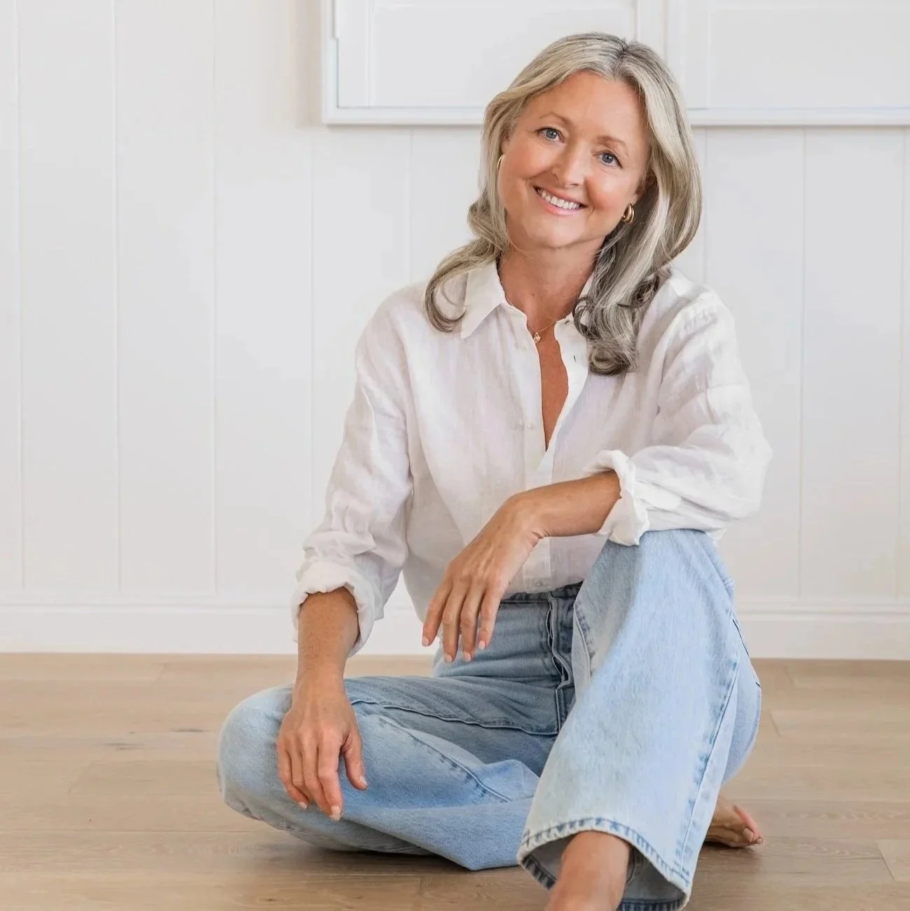 Anna Hutchins, clinical nutritionist, sitting on the floor and smiling