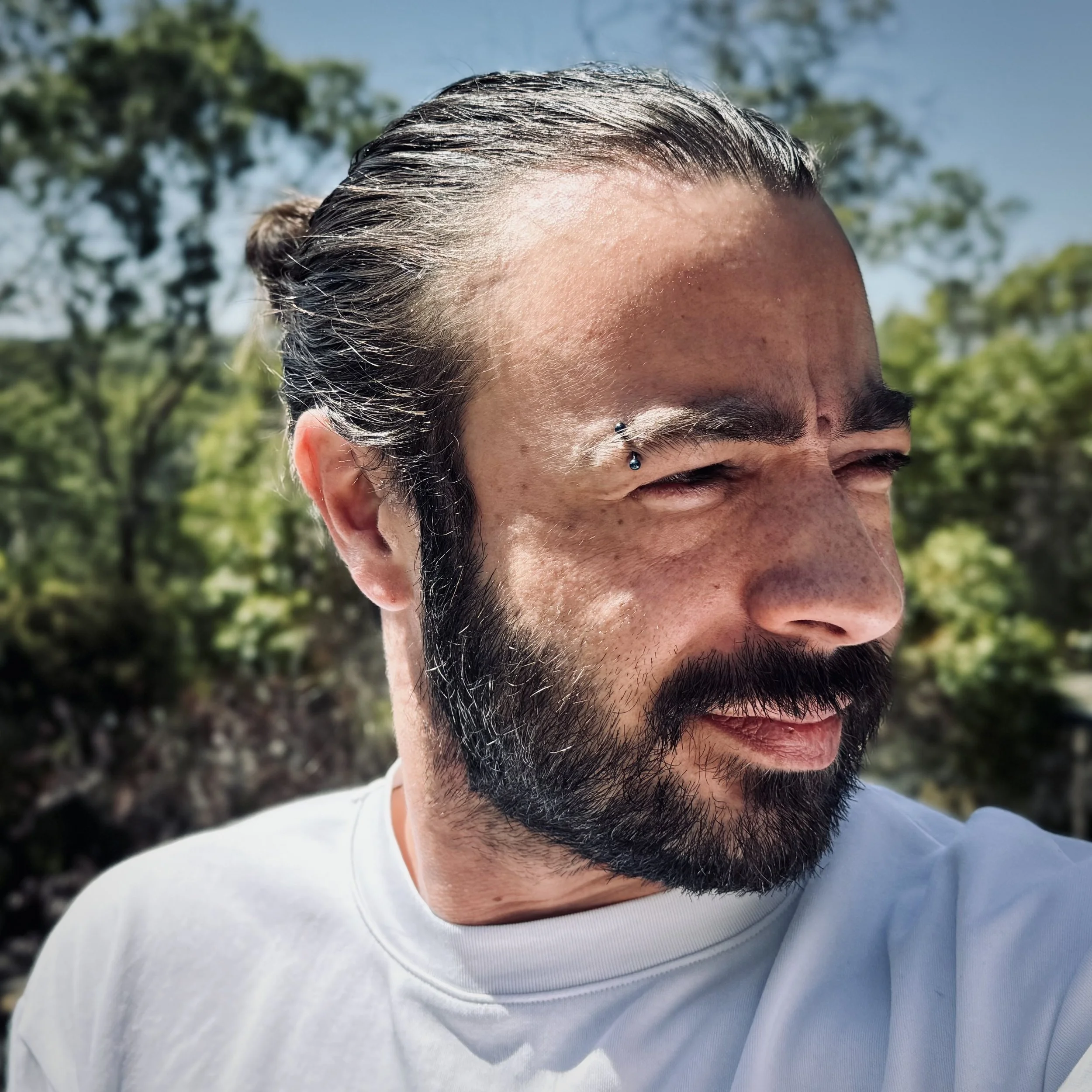 A photograph of Kieran Tie, looking to the right.