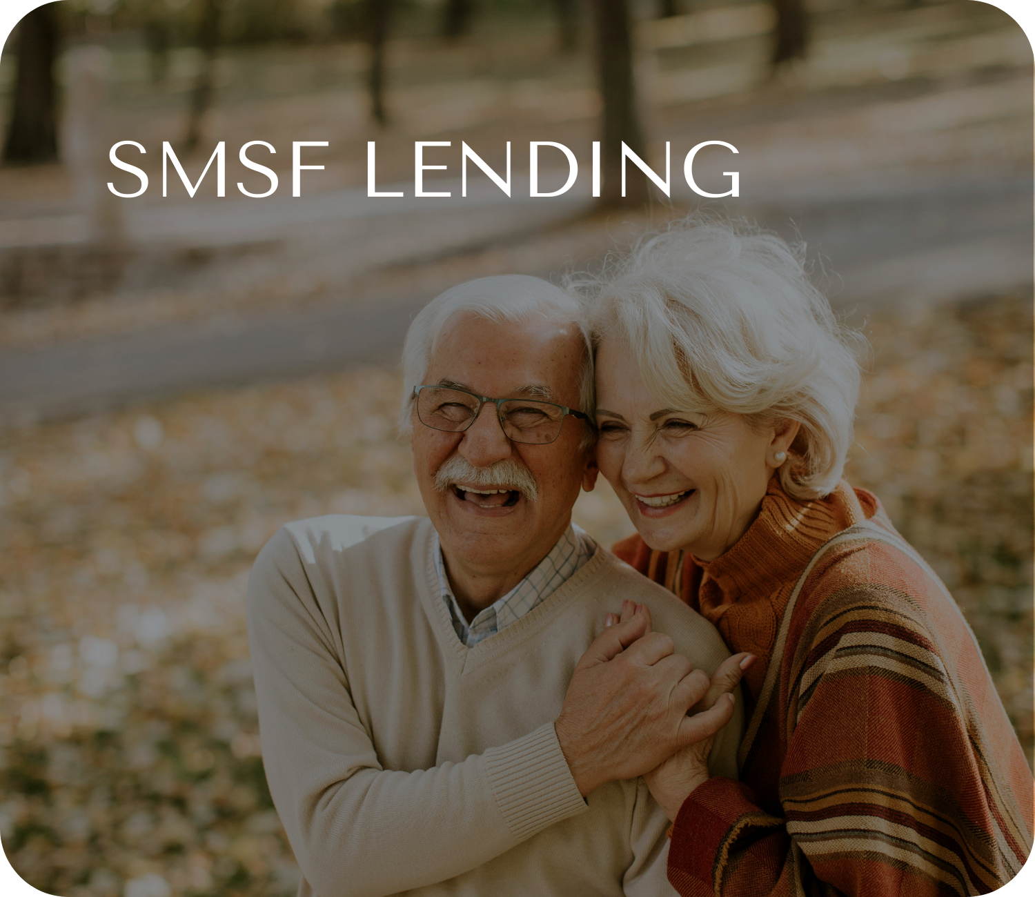 An elderly couple smiling and laughing outdoors in a park for SMSF lending solution at Baseline Financial
