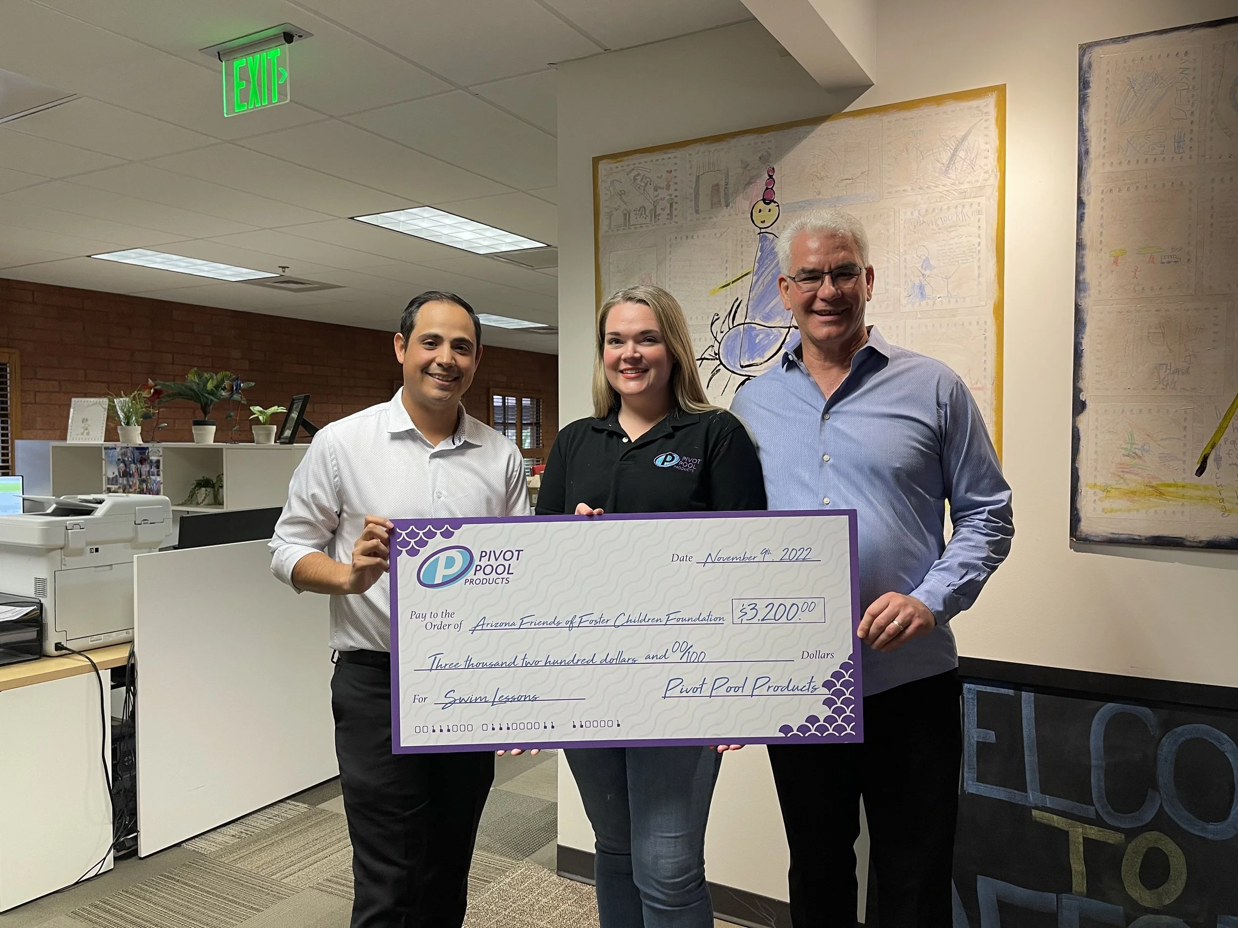  Taylor Cole of Be Sound PR and Paul Sim of Pivot Pool Products presents a gift to Arizona Friends of Foster Children Foundation.