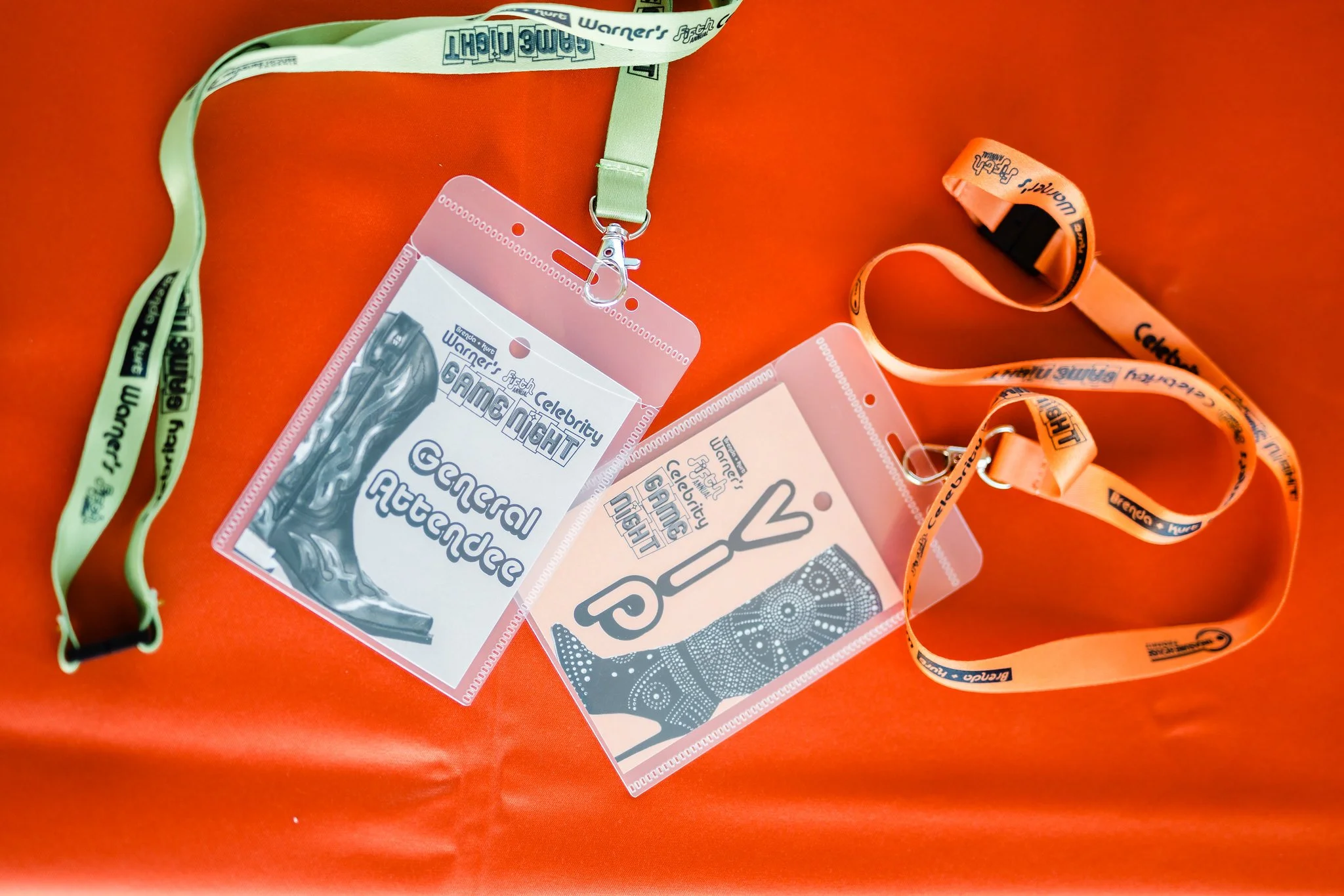 Festival badge holder and lanyard on an orange background.