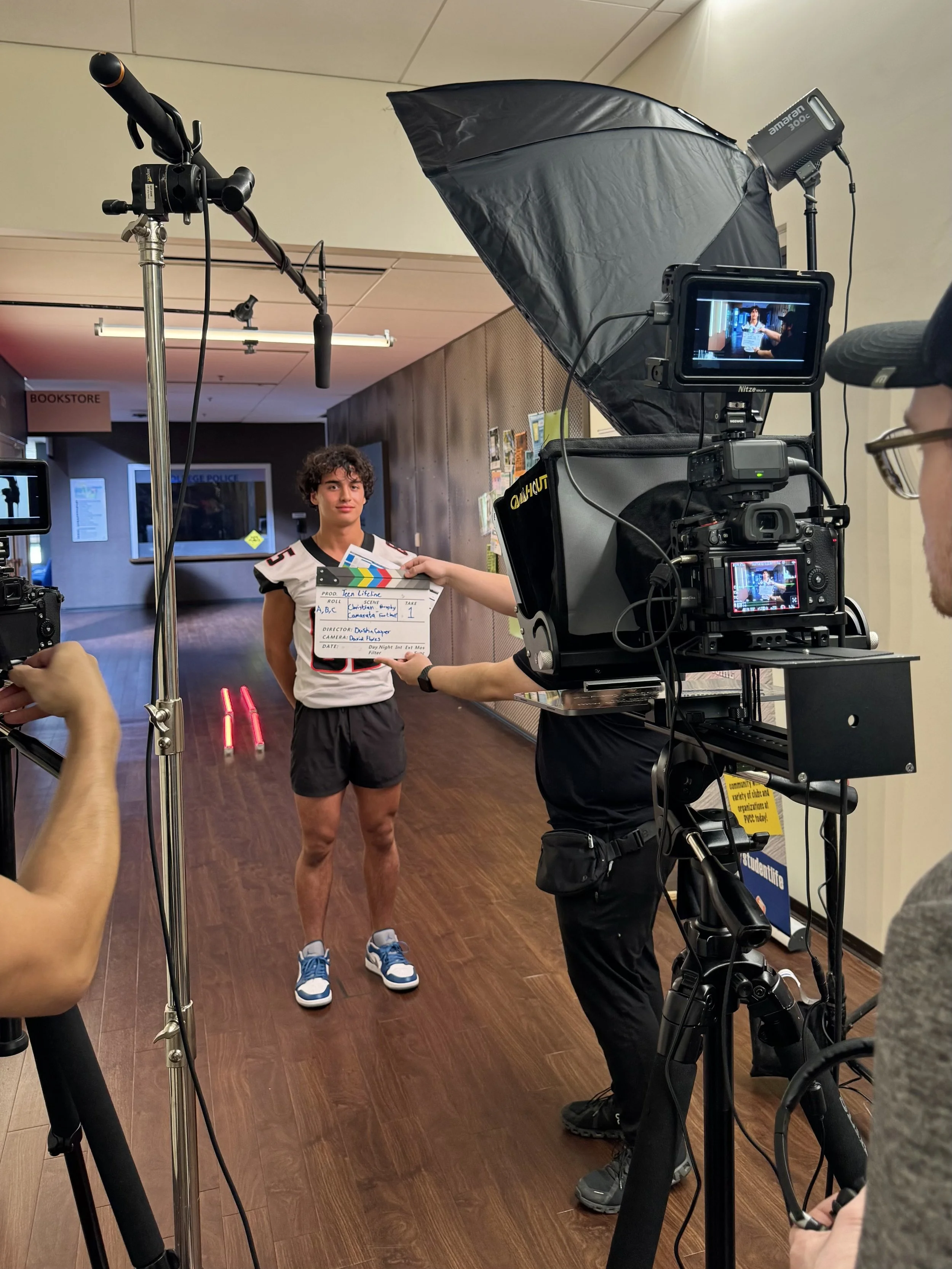 A high school football player films a Teen Lifeline Messages of Hope PSA for Teen Suicide Prevention Awareness Month. Taylor Cole of Be Sound PR produces the annual campaign.