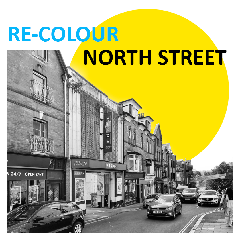 Street scene with shops and cars, black-and-white image with a yellow circle in the background containing the text 'RE-COLOUR NORTH STREET'.