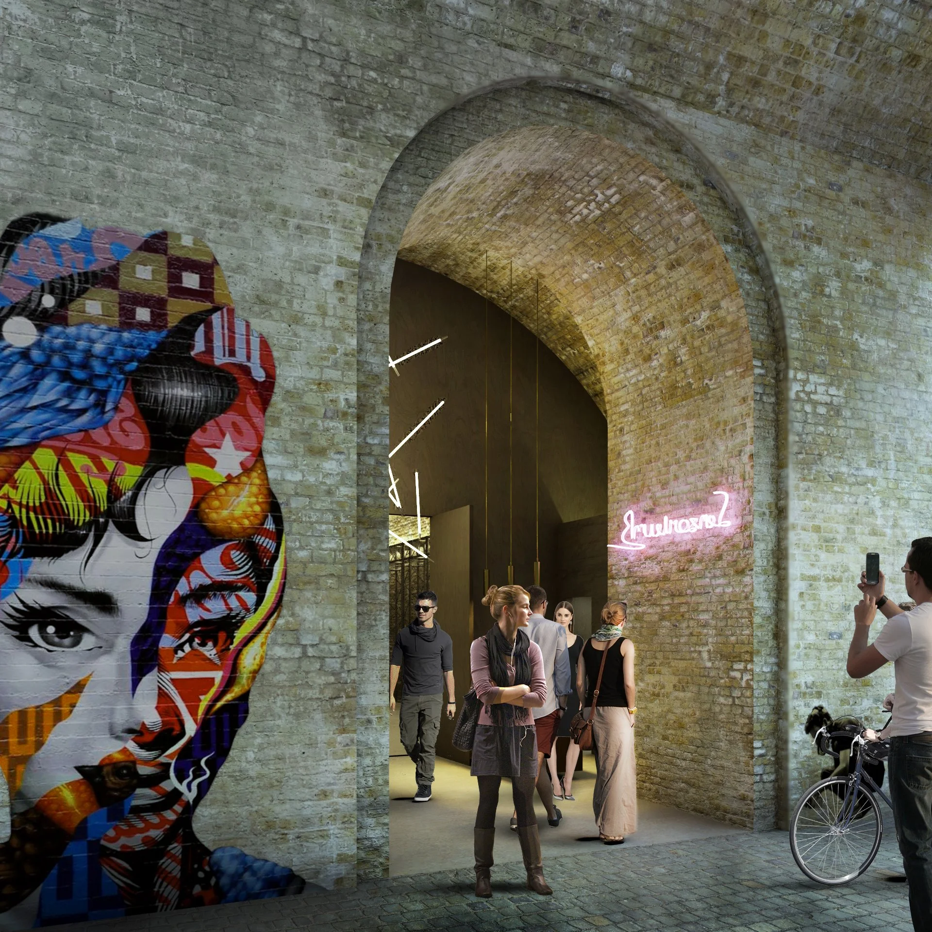 People walk through an art gallery with exposed brick walls and modern art installations, including a colorful mural of a woman's face.