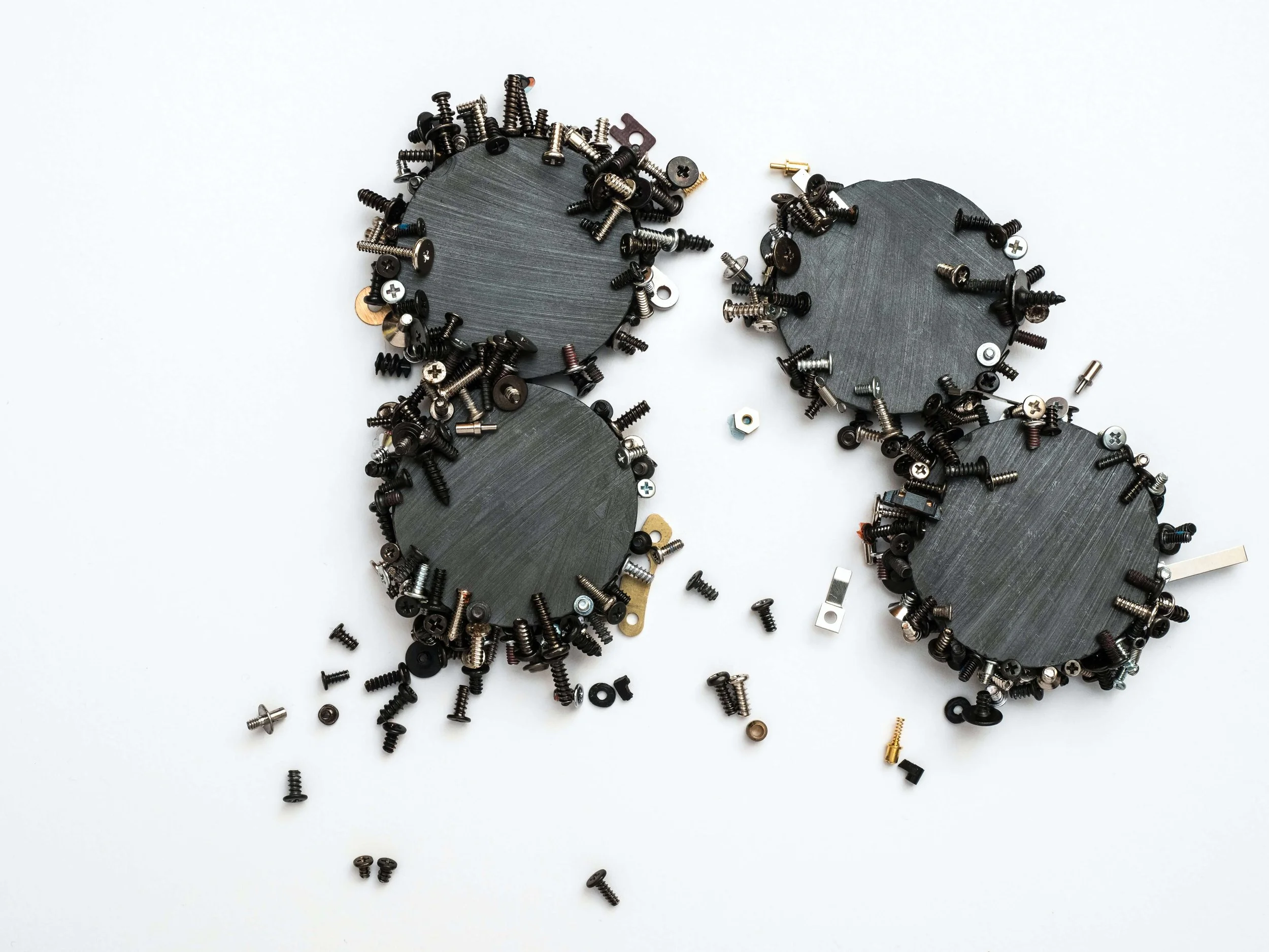 A conceptual image of boardroom dynamics: circular forms and scattered components symbolize the intricate process of executive search and board formation, where HamptonTCI aligns leadership talent and crafts the optimal board mix for PE and Owners