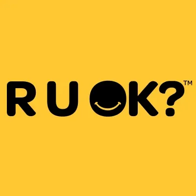 Yellow background with the word "R U OK?" in black text, featuring a smiley face in the letter "O"