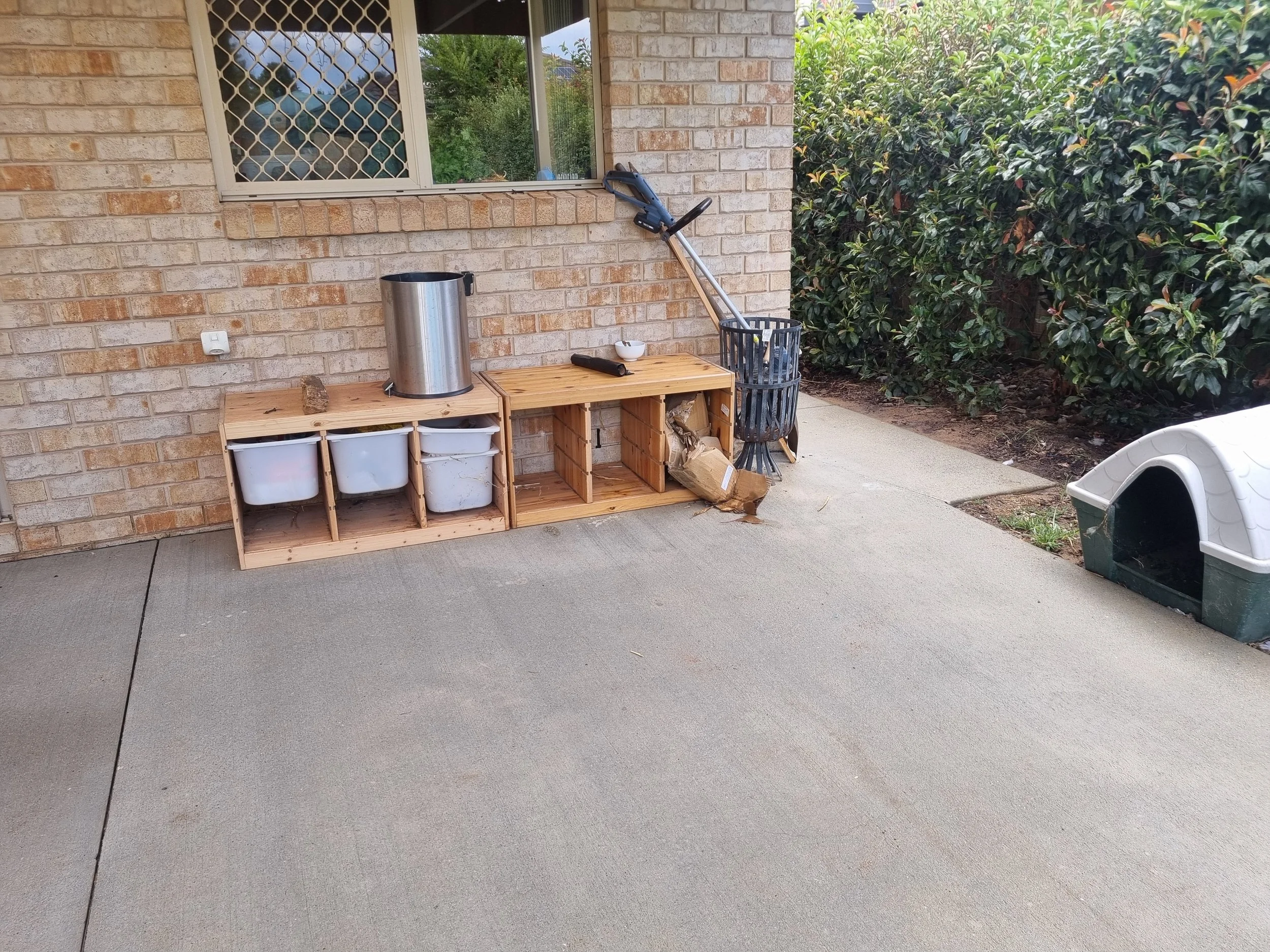 Backyard patio with a brick wall, a window with security screen, the canberra backyard patio has been pressure cleaned.