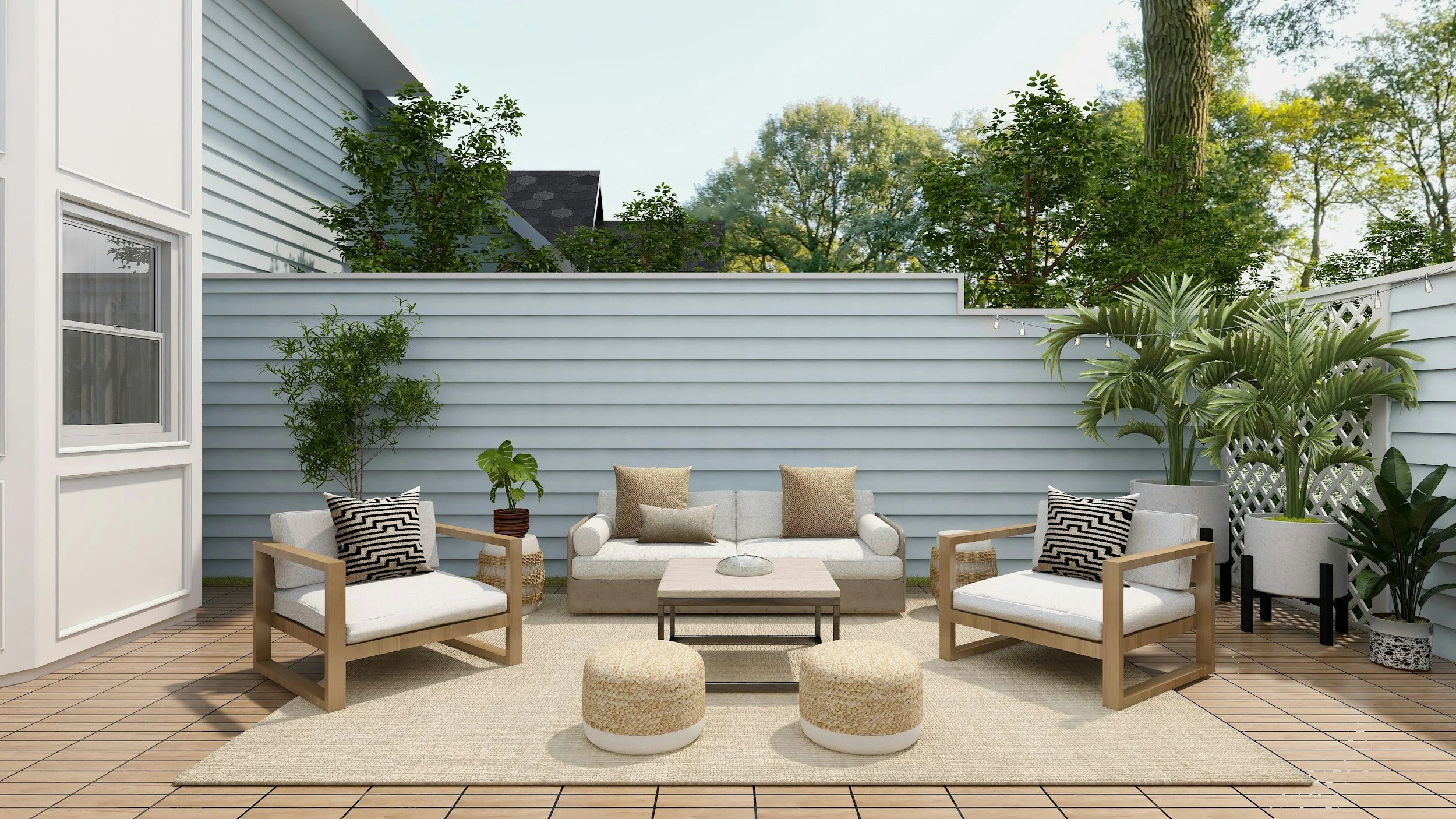 Outdoor patio with a beige sofa, two beige armchairs, a coffee table, two round ottomans, and various potted plants, enclosed by a gray wooden fence with string lights overhead.