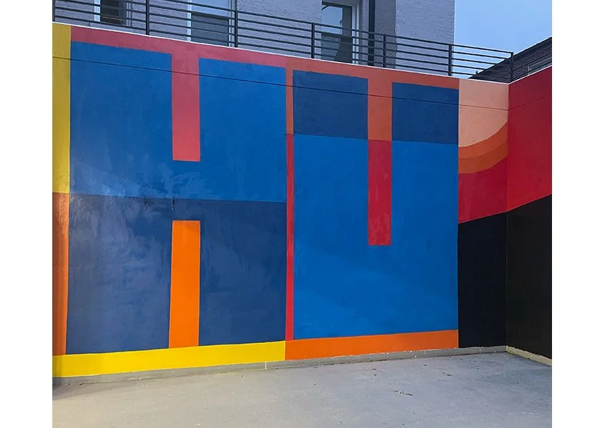 Image of Mural wall with The Letters H and U in light blue and dark blue