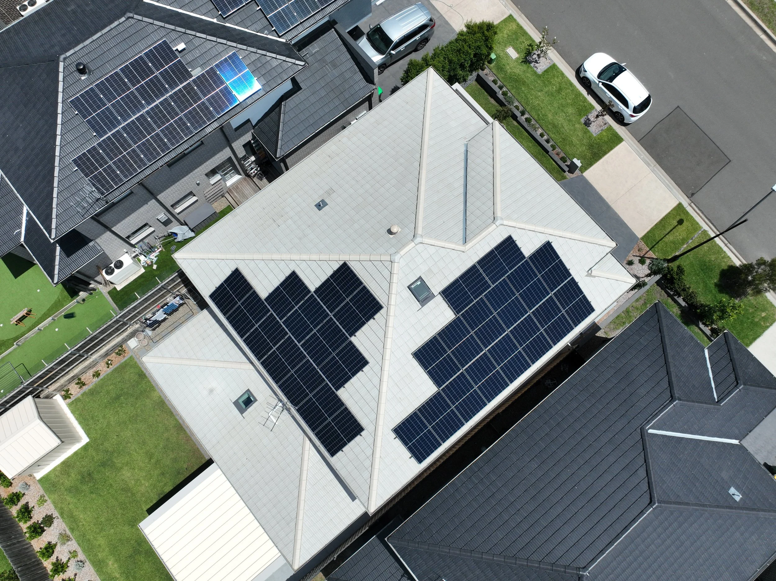 Aerial view of houses with solar panels on rooftops