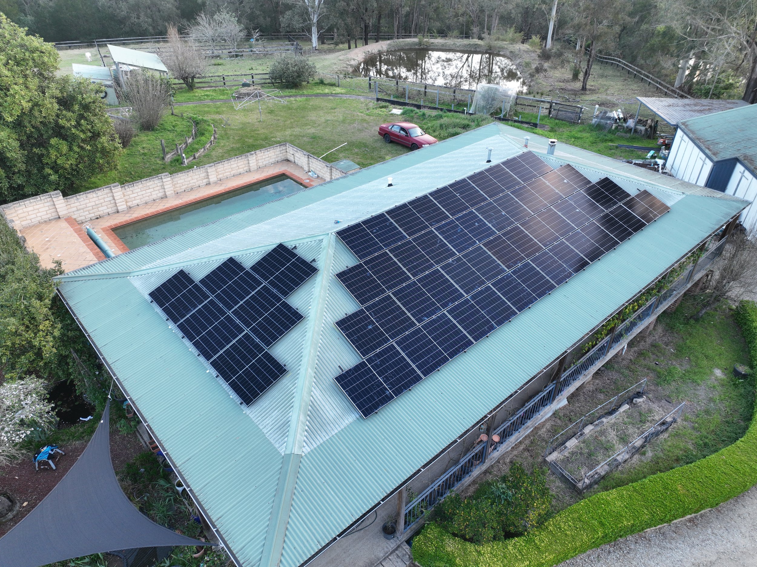 Aerial view of a house with solar panels installed by Kennedys in Sydney