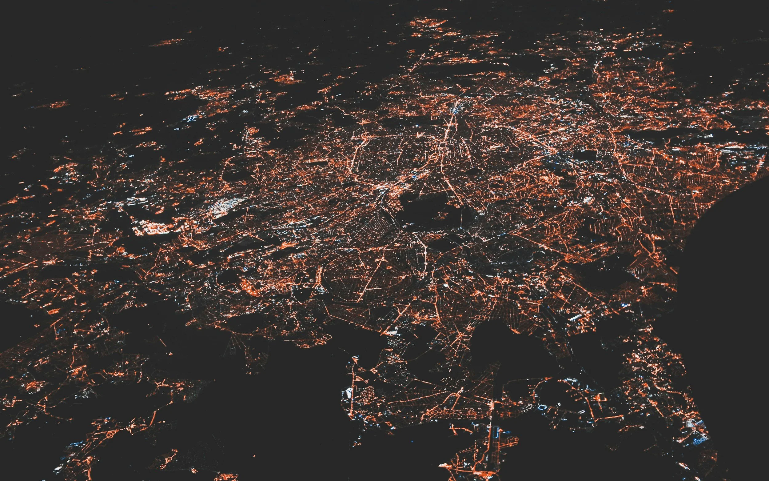 A aerial view of a major Asian city, typically seen when flying into places like India and China at night