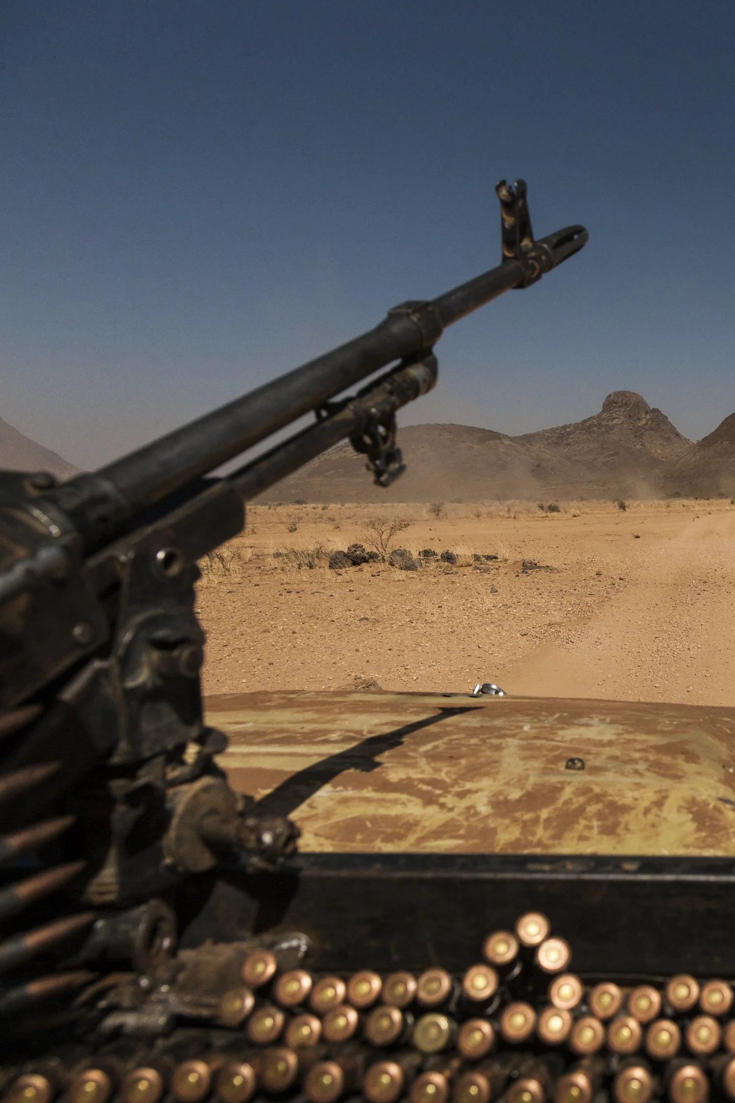 A vehicle-mounted machine gun pointed across the Darfur desert — the cover photograph of Blood Money