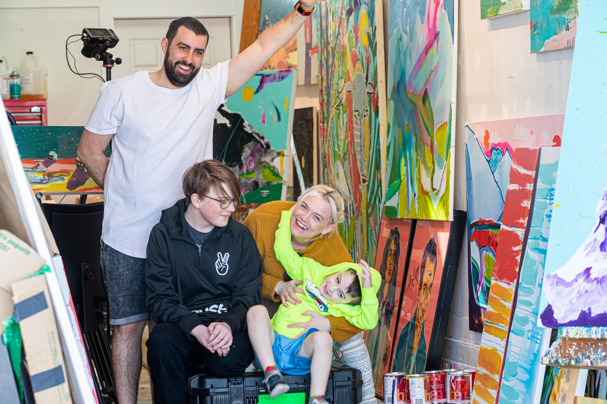 Mandy Stobo of Bad Portraits in her art studio with her family in Bozeman Montana, Mandy is a Founding artist of Karma Ranch
