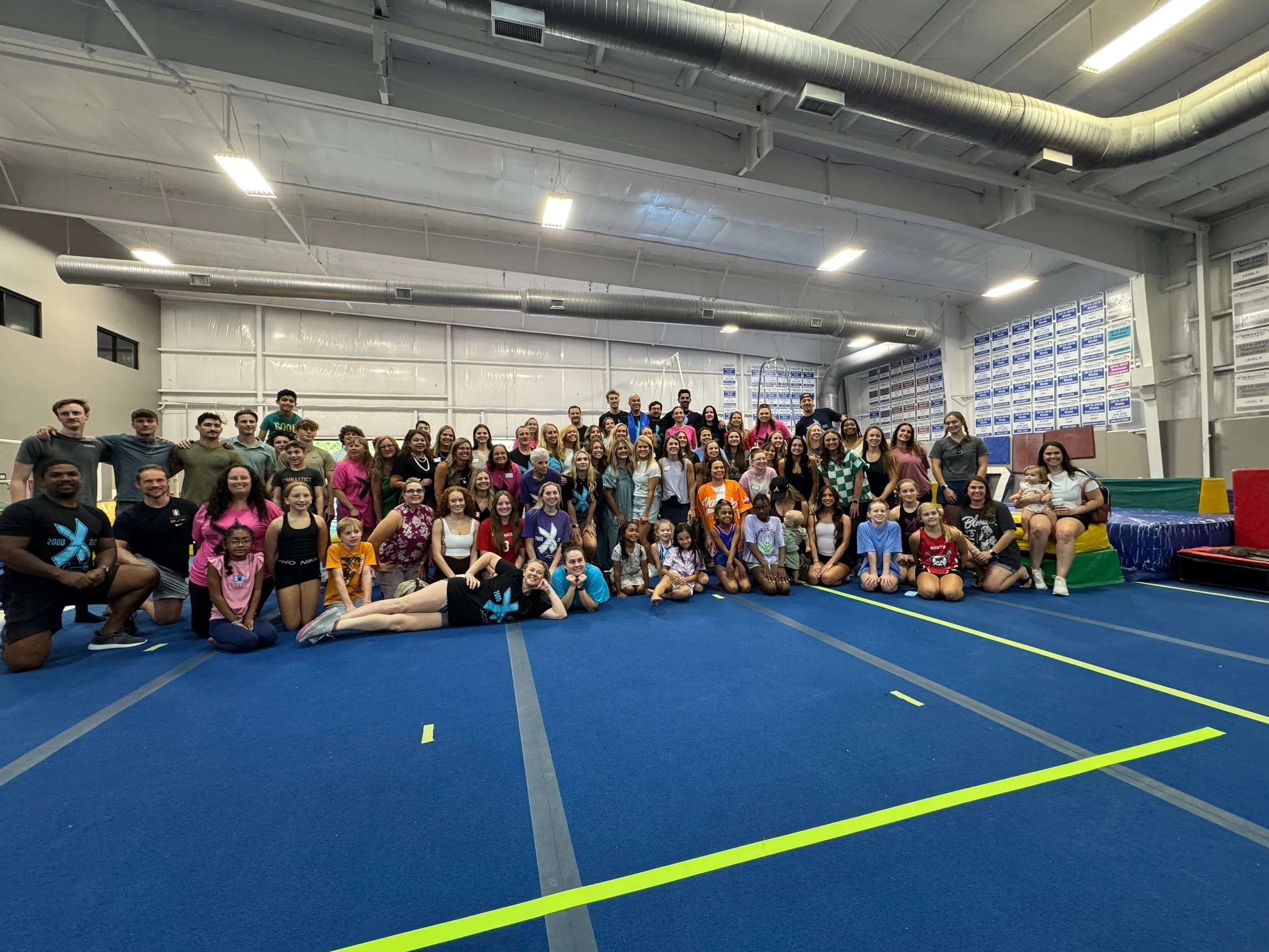 Girls and boys gymnasts in a large gym