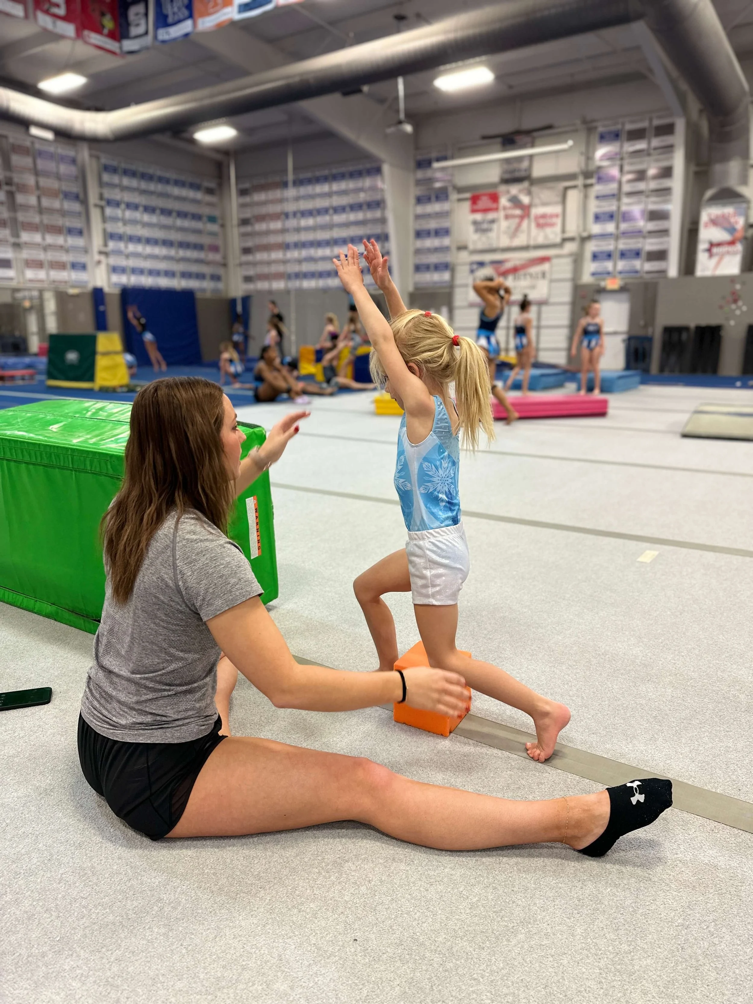 gymnast with coach in gym