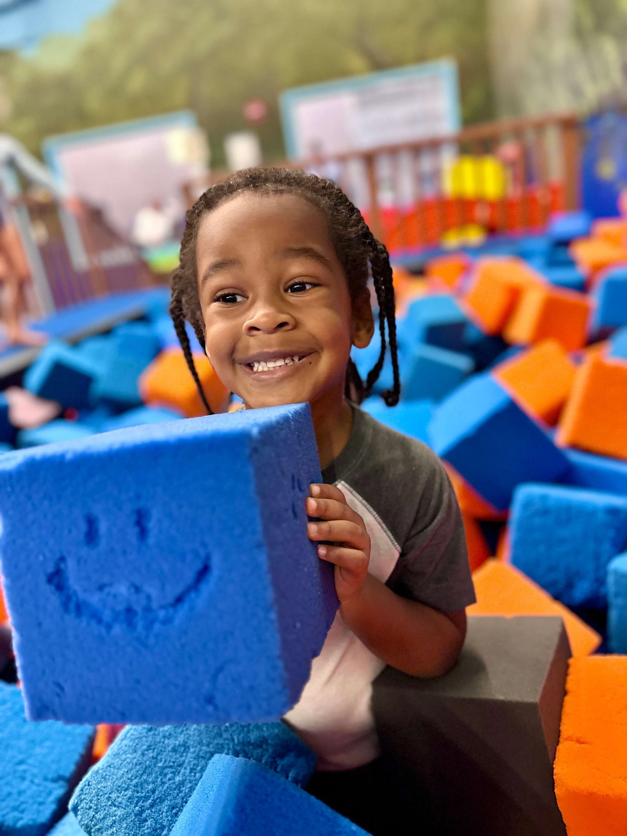 little kid holding a tumbling block