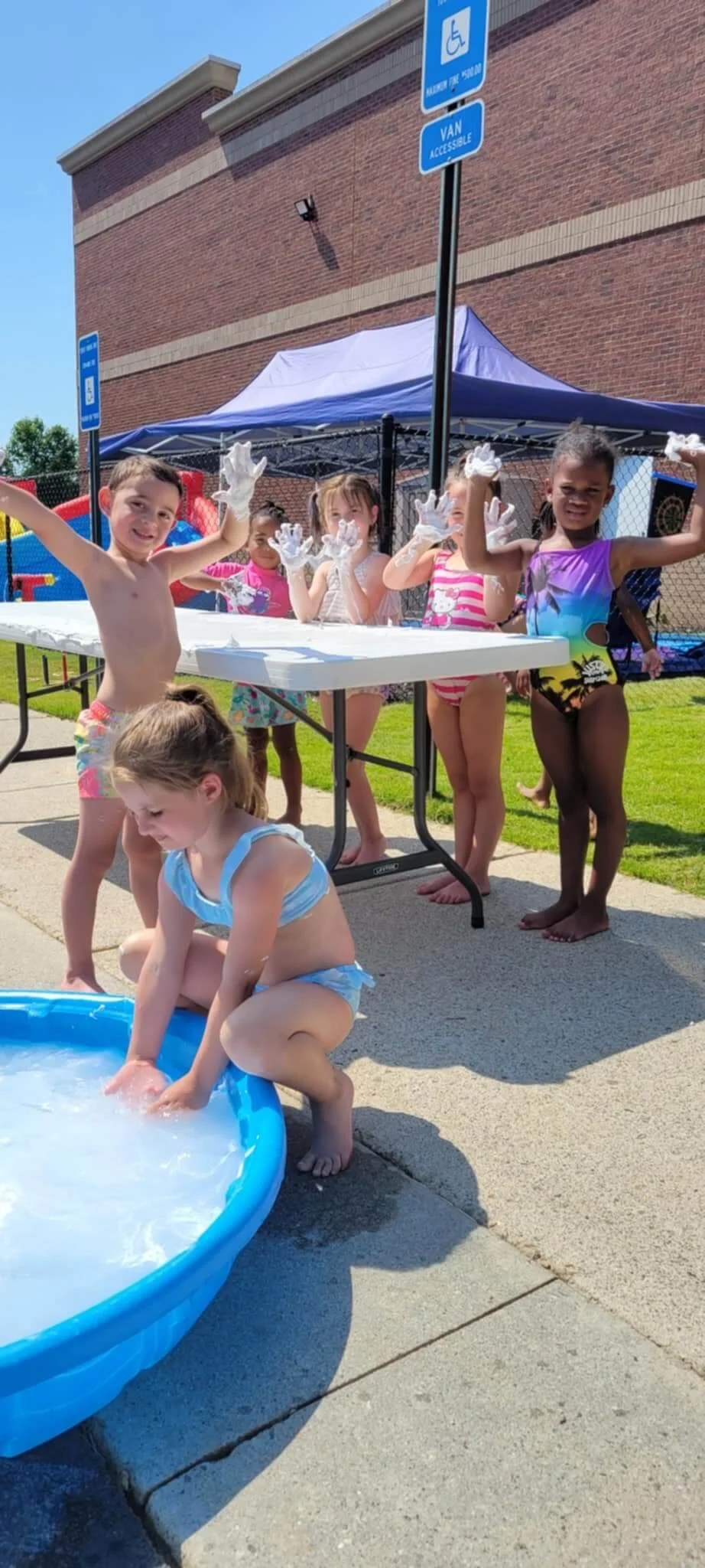 Kids outside with shaving cream on their hands at summer camp