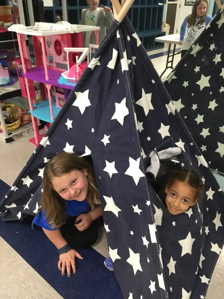 two girls in tent at after school program