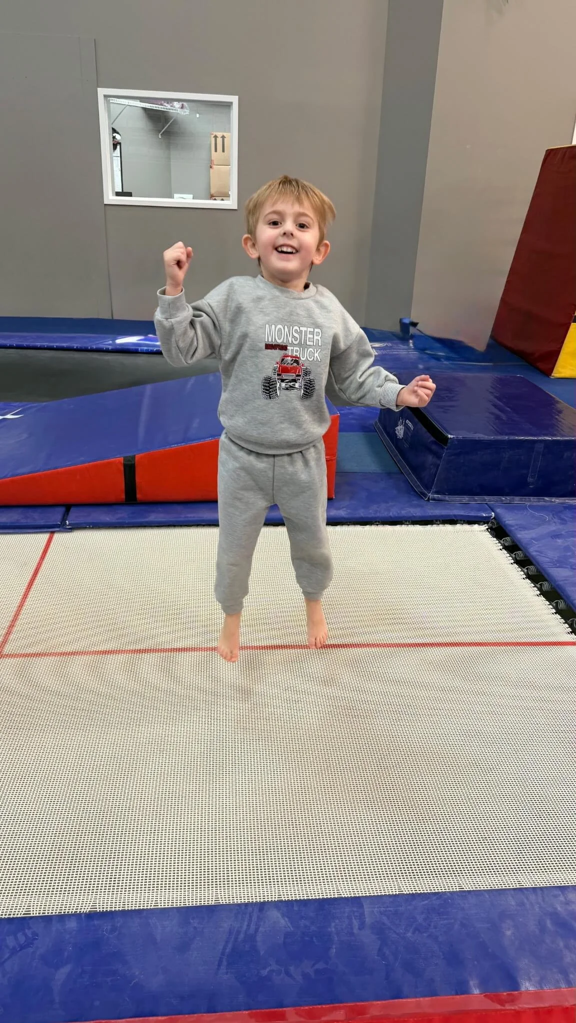 little boy jumping in a gymnastics gym